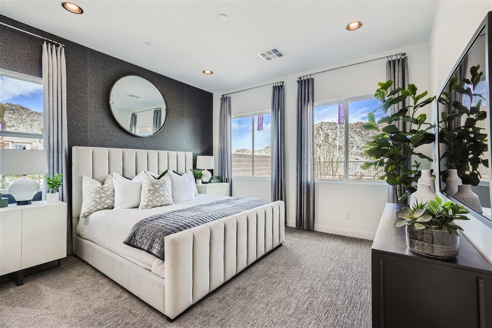 A bedroom with a large window.