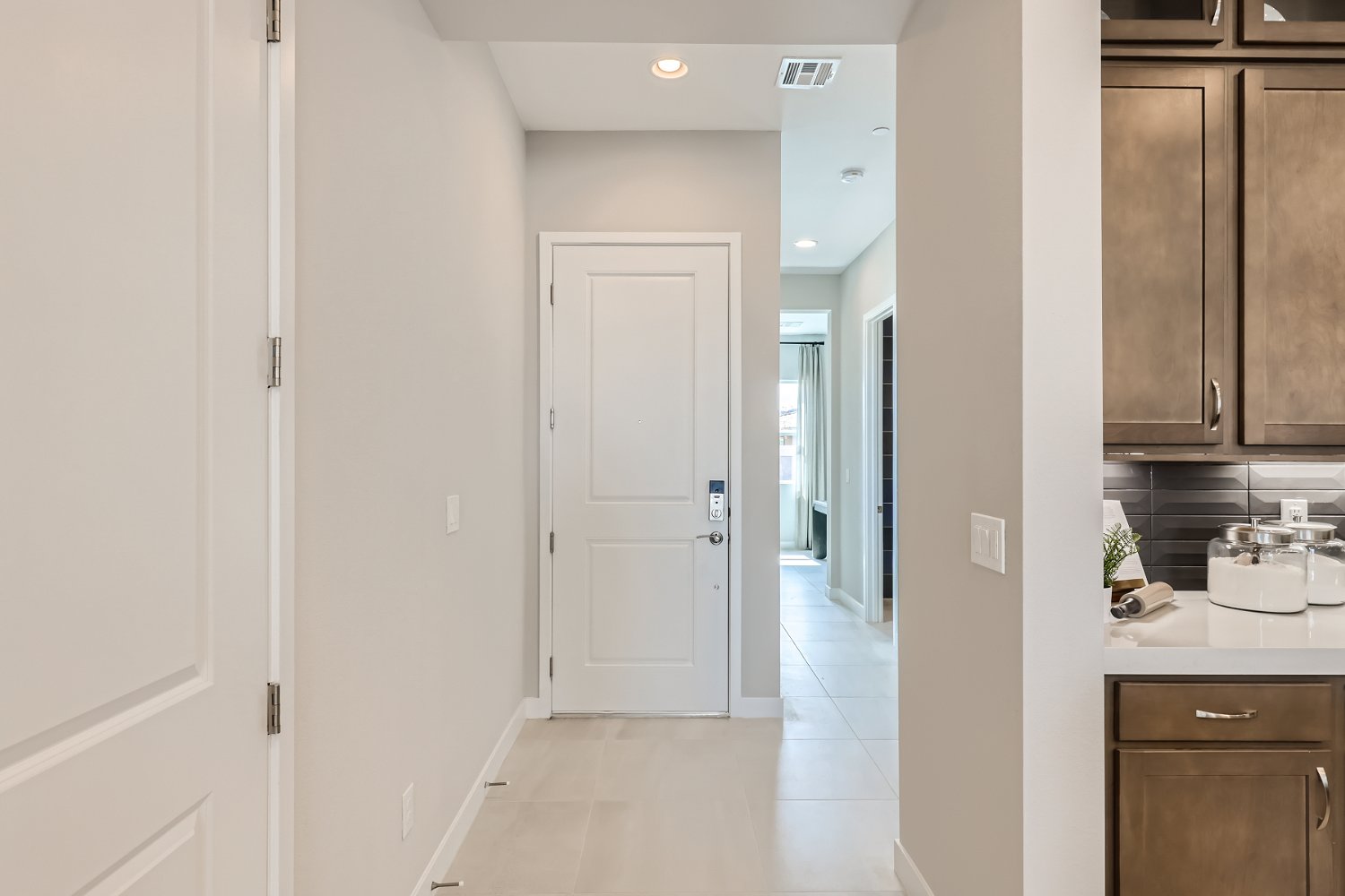 A kitchen with white cabinets.