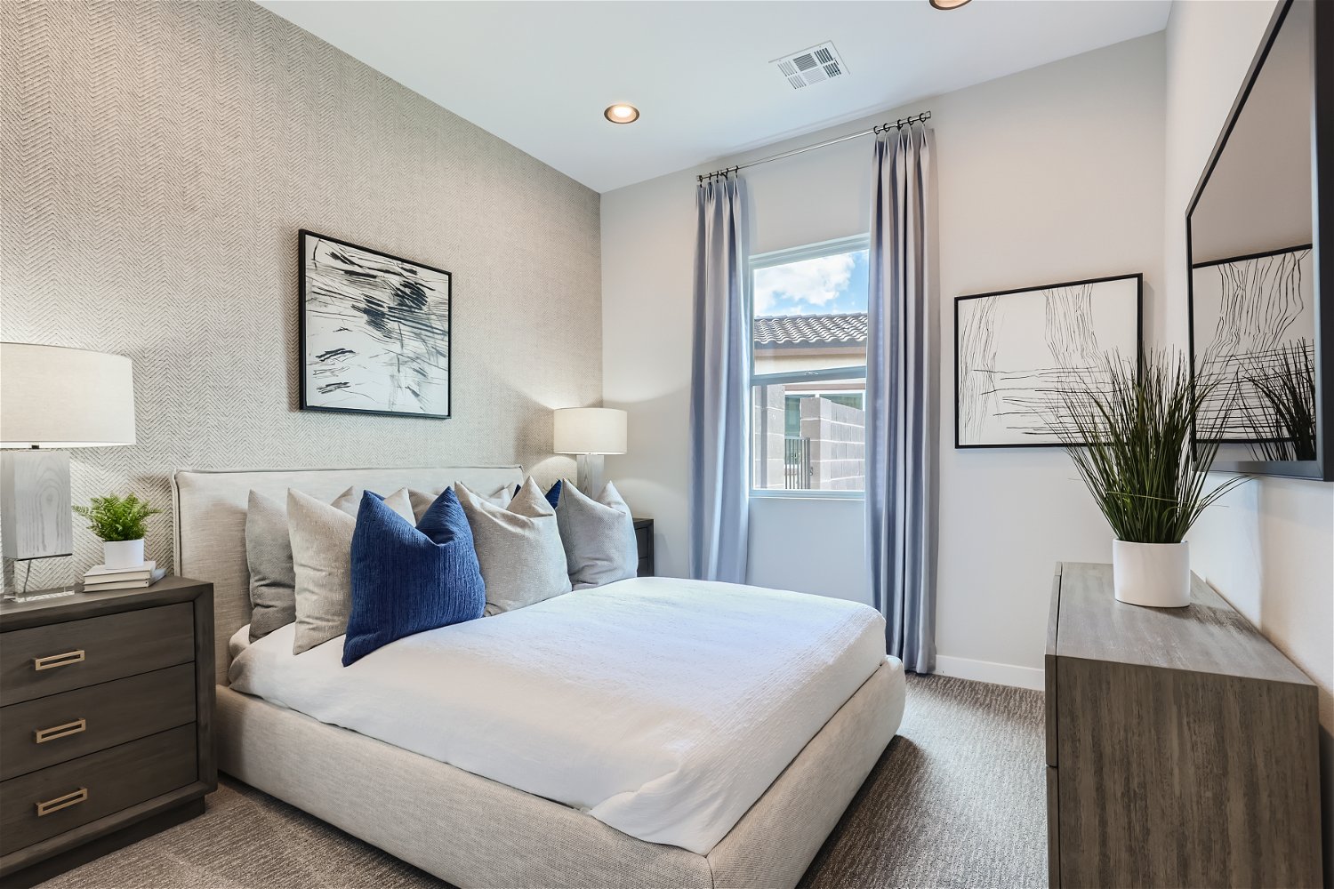 A bedroom with a bed and a window.