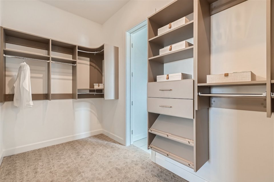 A room with a shelf and a door.