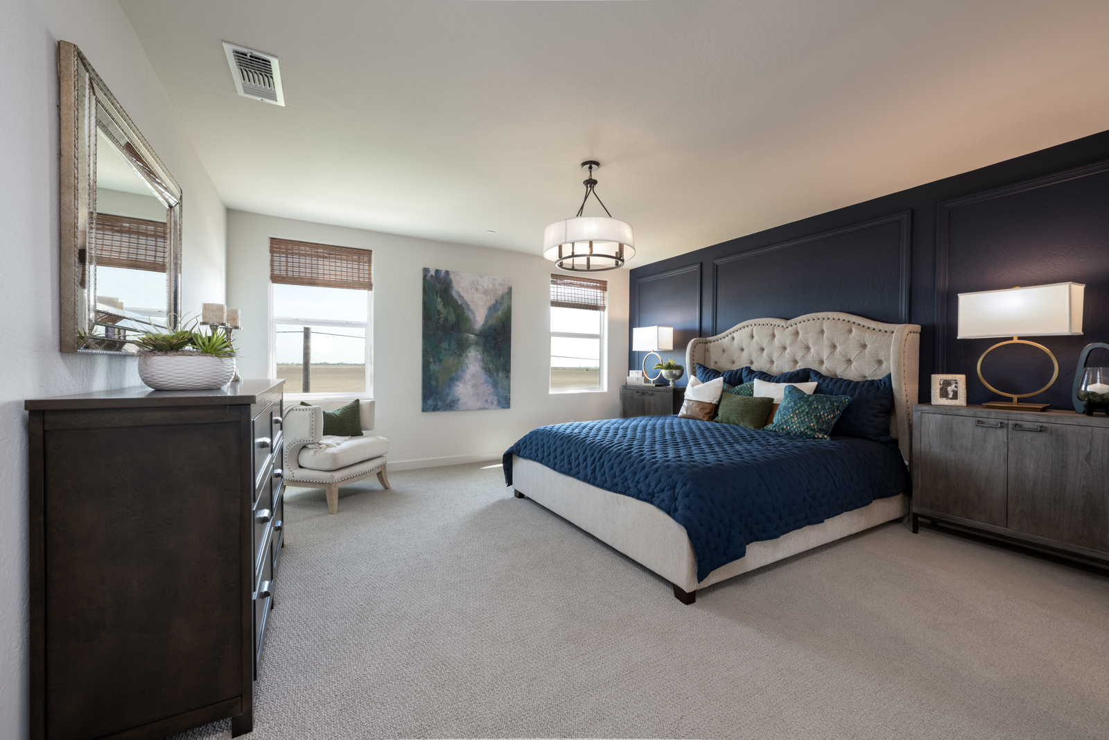 A bedroom with a bed and a chair.