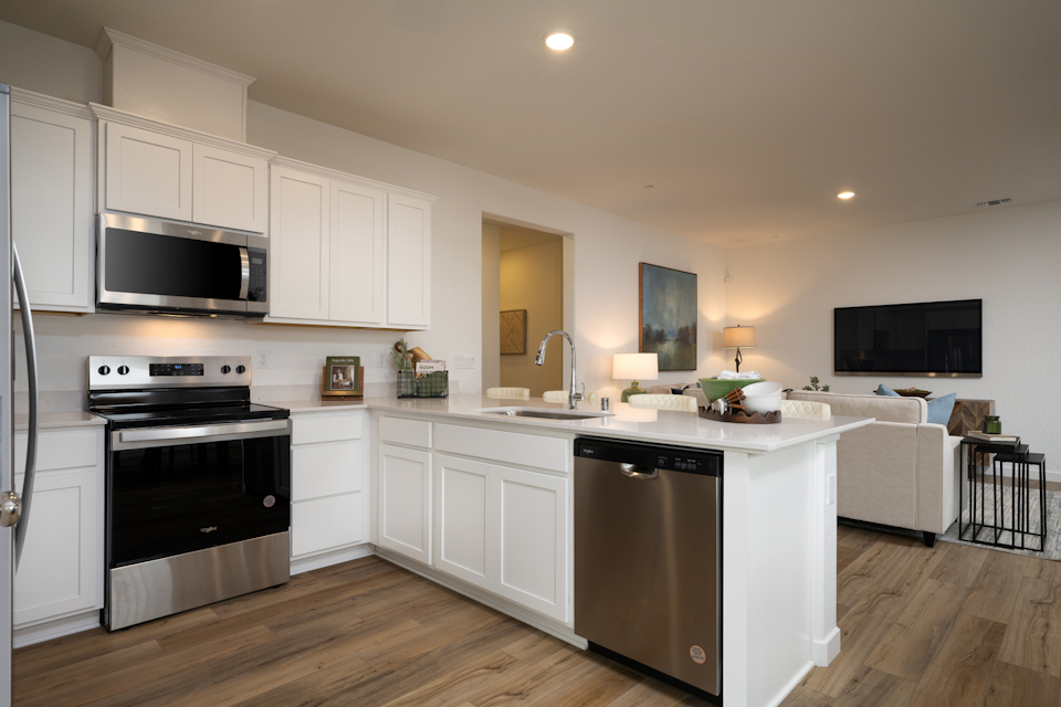 A kitchen with white cabinets.