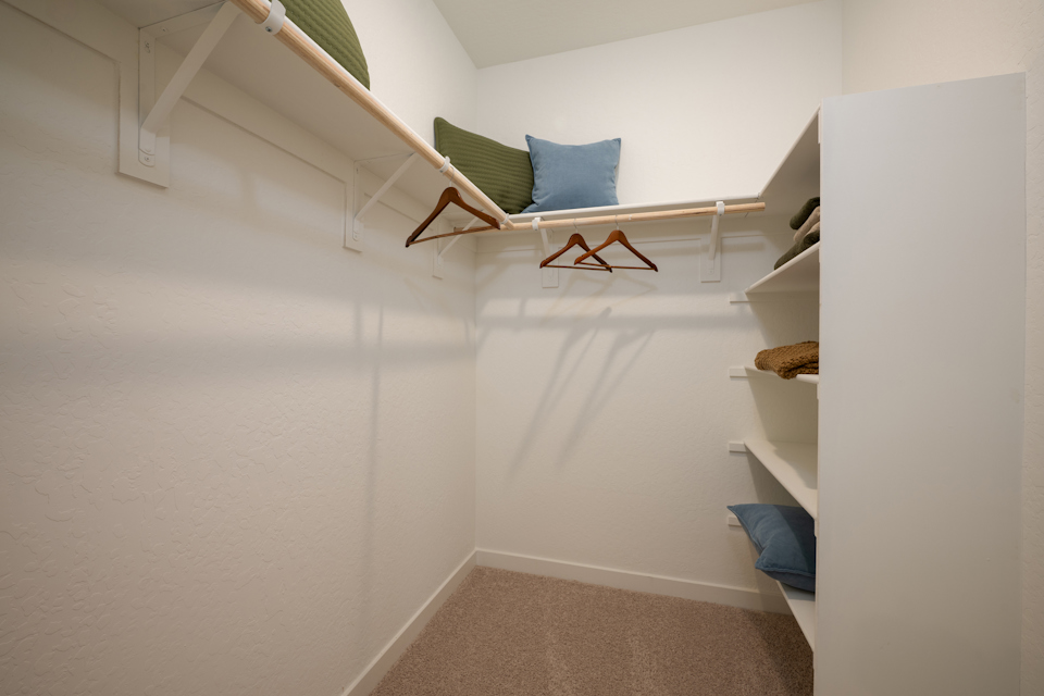 A room with a bed and a bench.