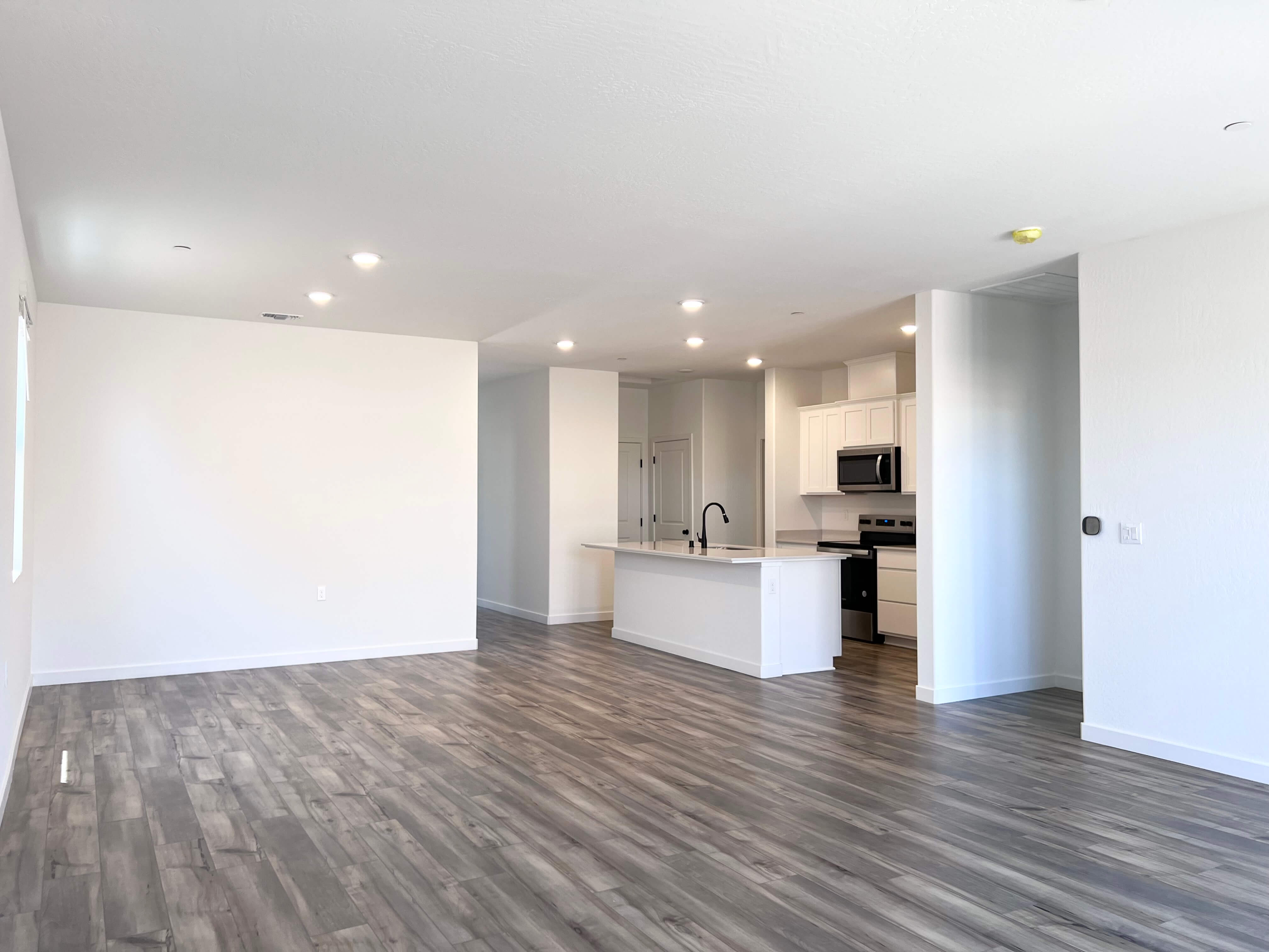 A large kitchen with white walls.
