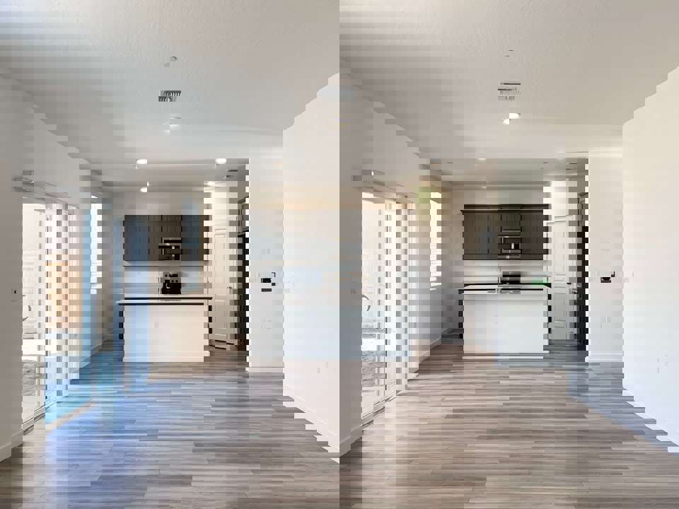 A large kitchen with white cabinets.