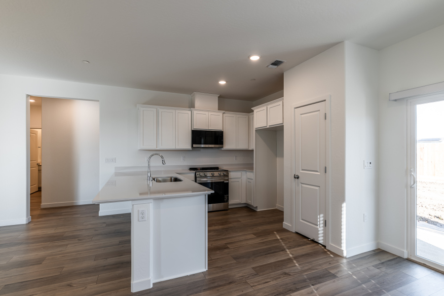 A kitchen with white cabinets.