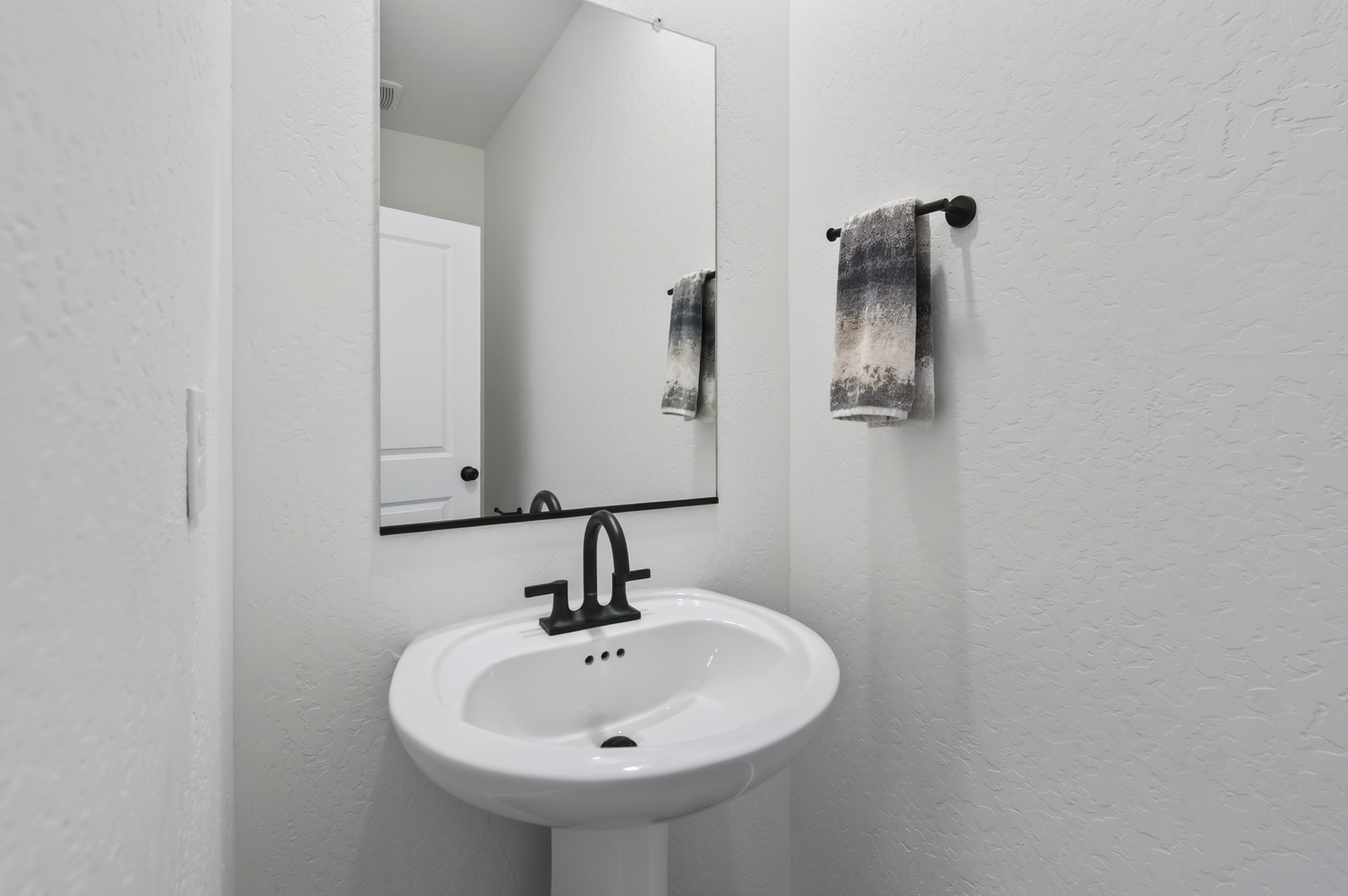 A bathroom with a mirror and sink.