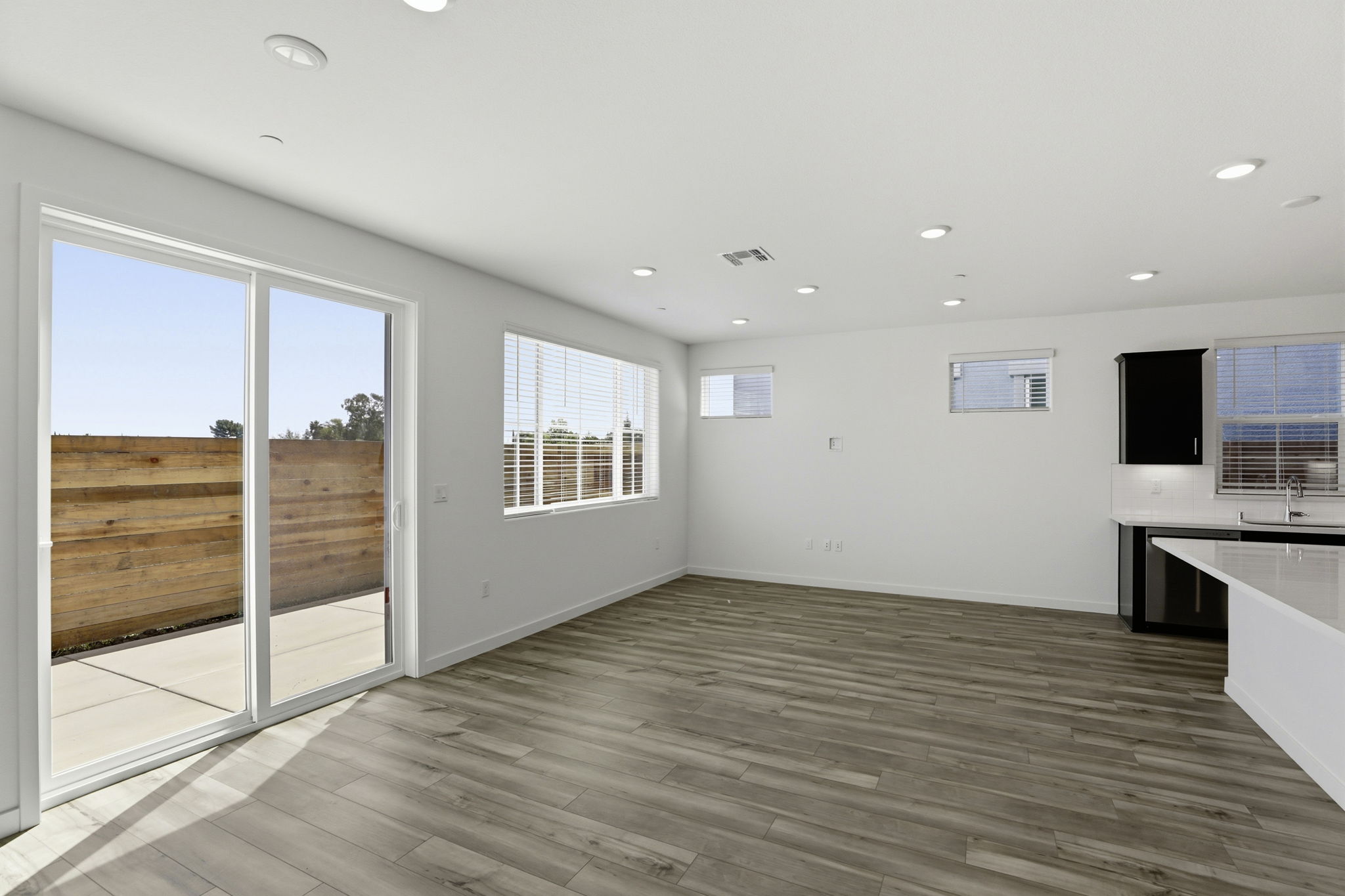 A room with a wood floor and windows.