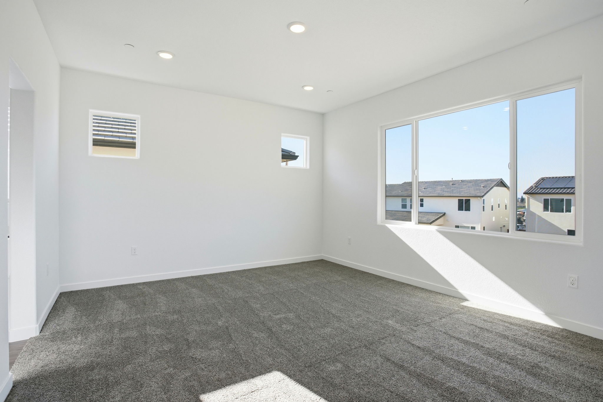 A room with a window and a view of the water.