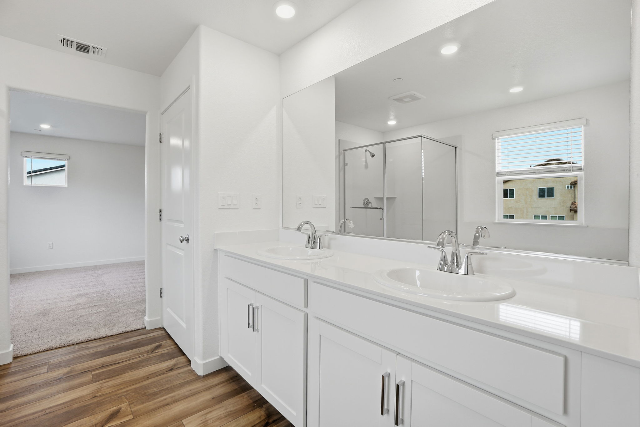 A bathroom with white cabinets.