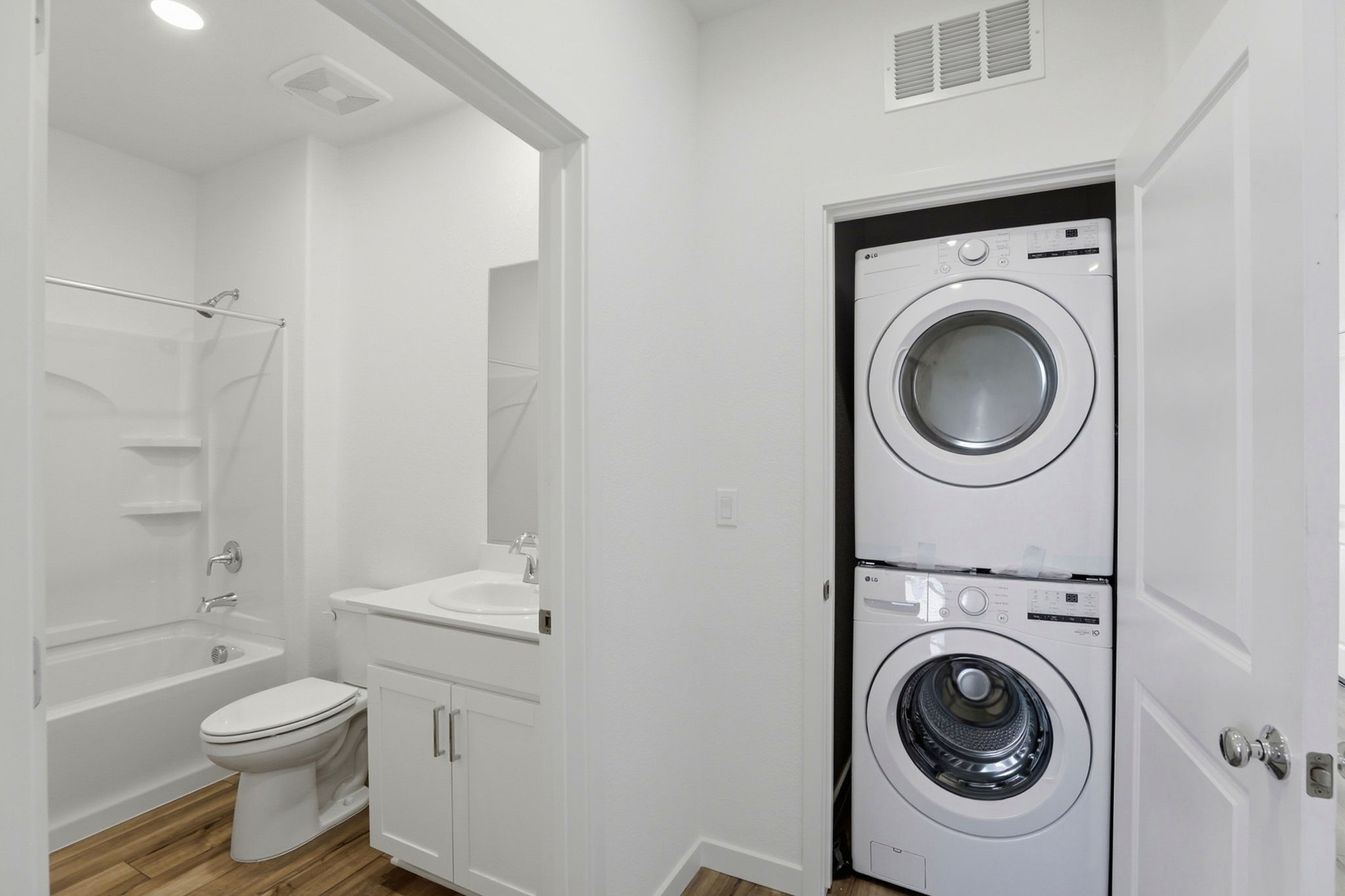 A bathroom with a washer and dryer.