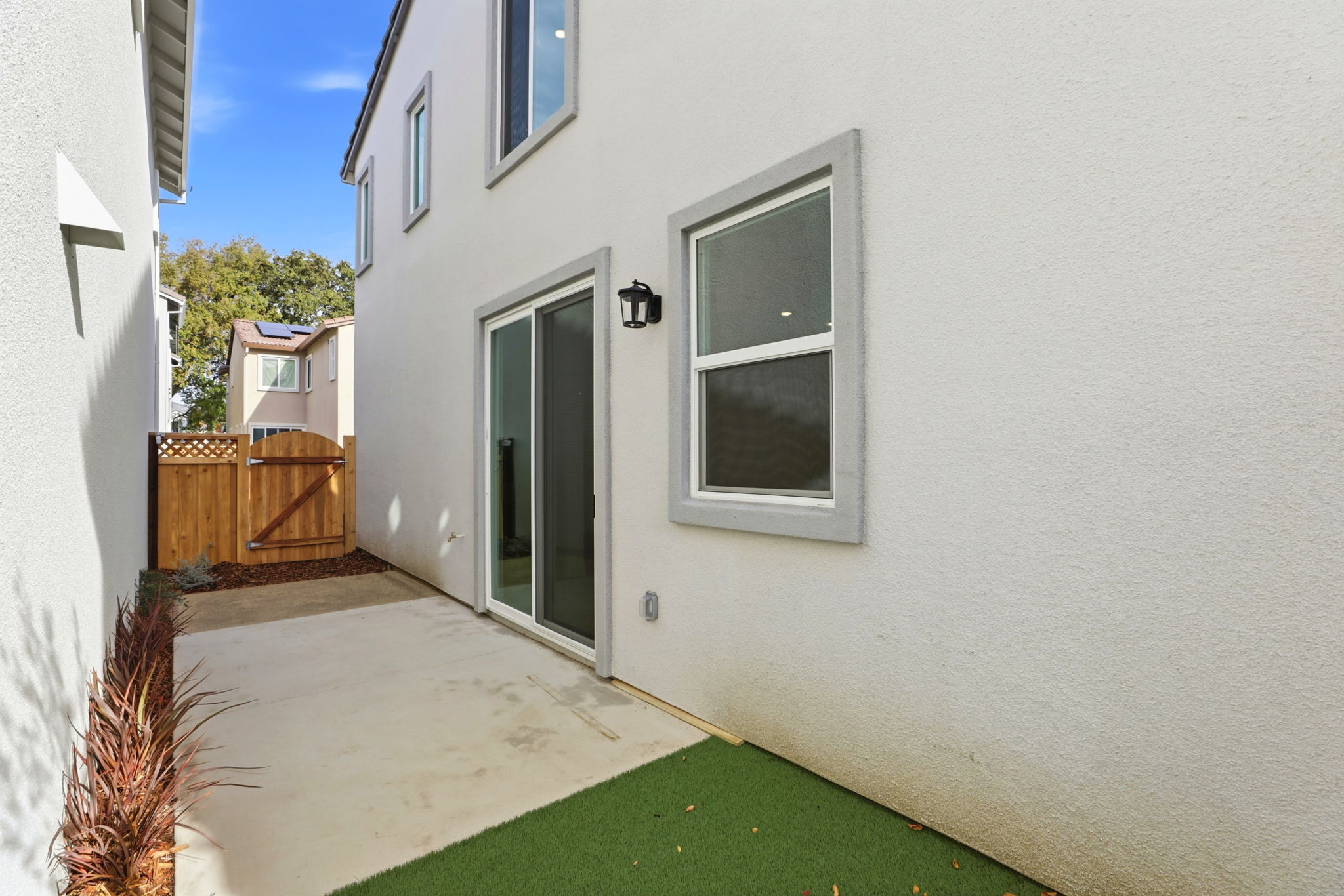 A white house with a green lawn.