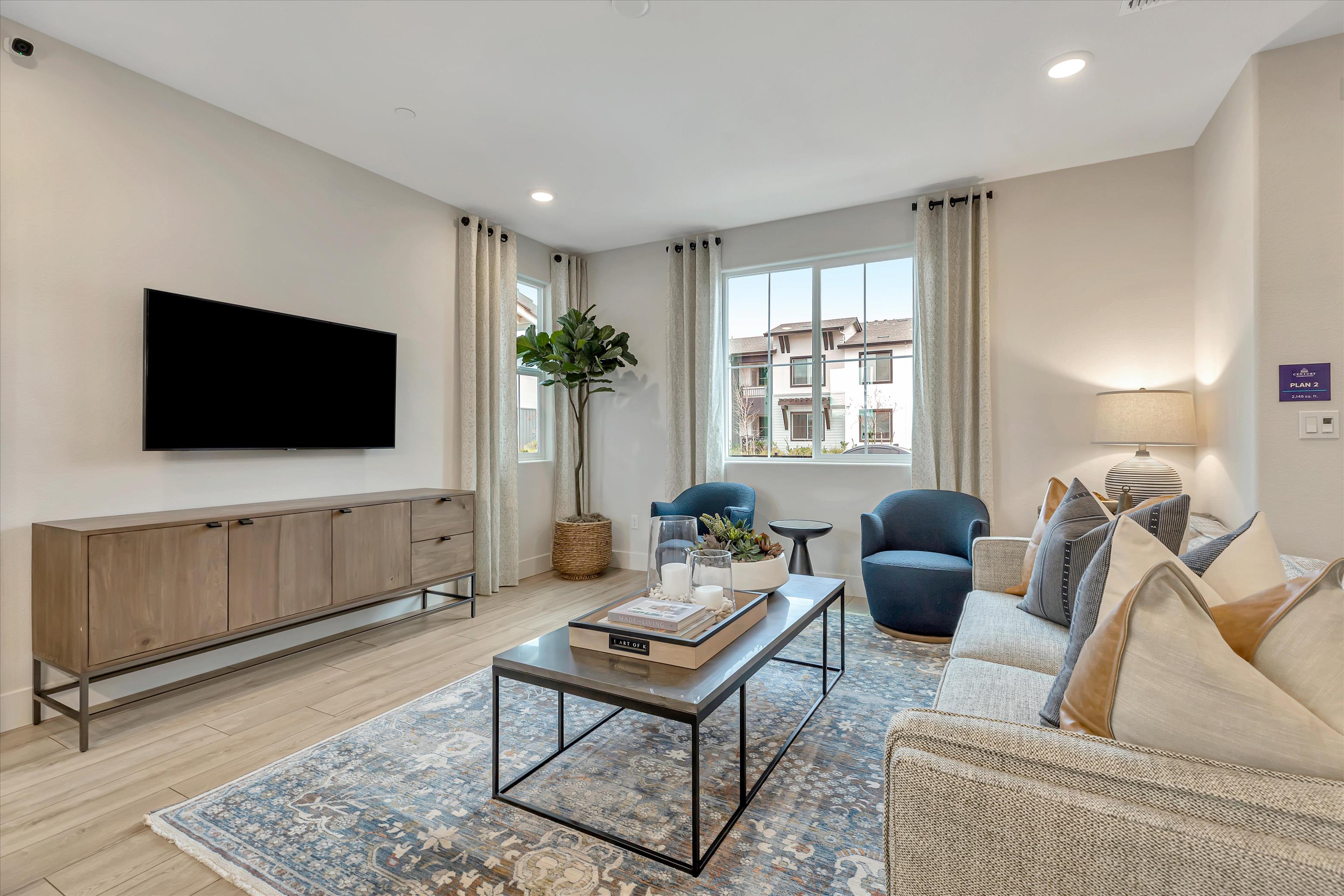 A living room with a tv and couches.