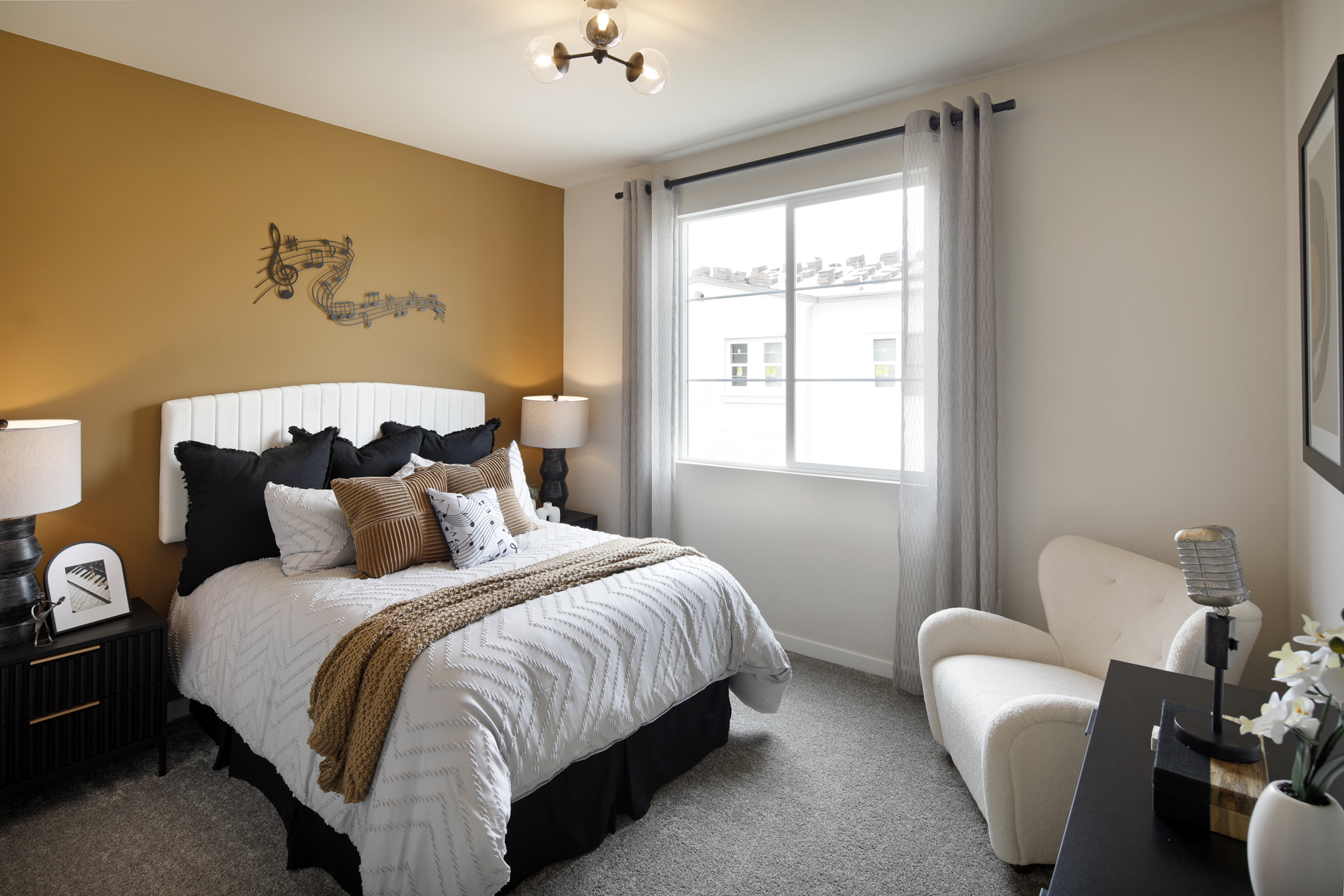 A bedroom with a bed and a chair.