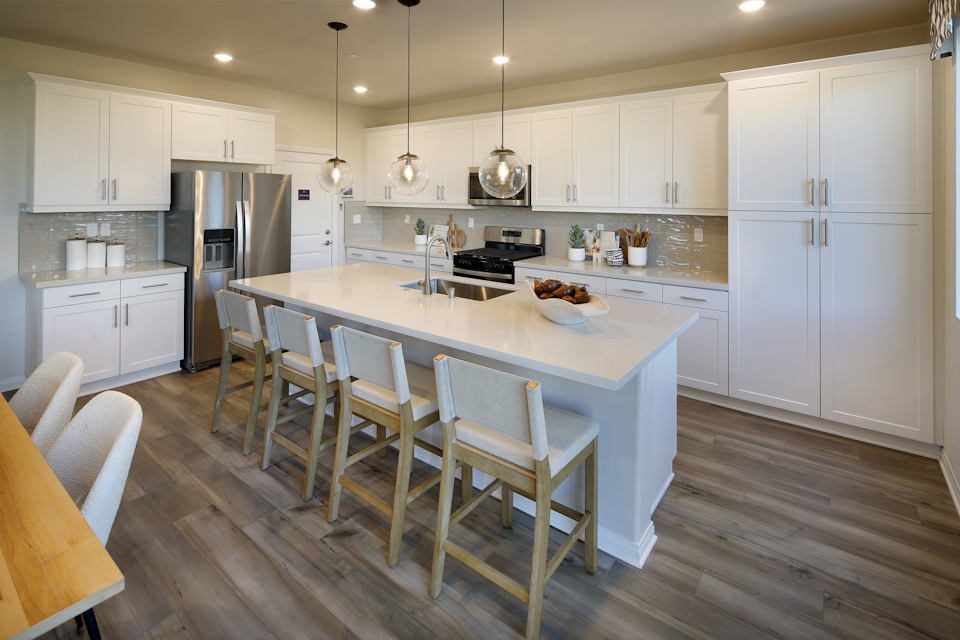 A kitchen with white cabinets.