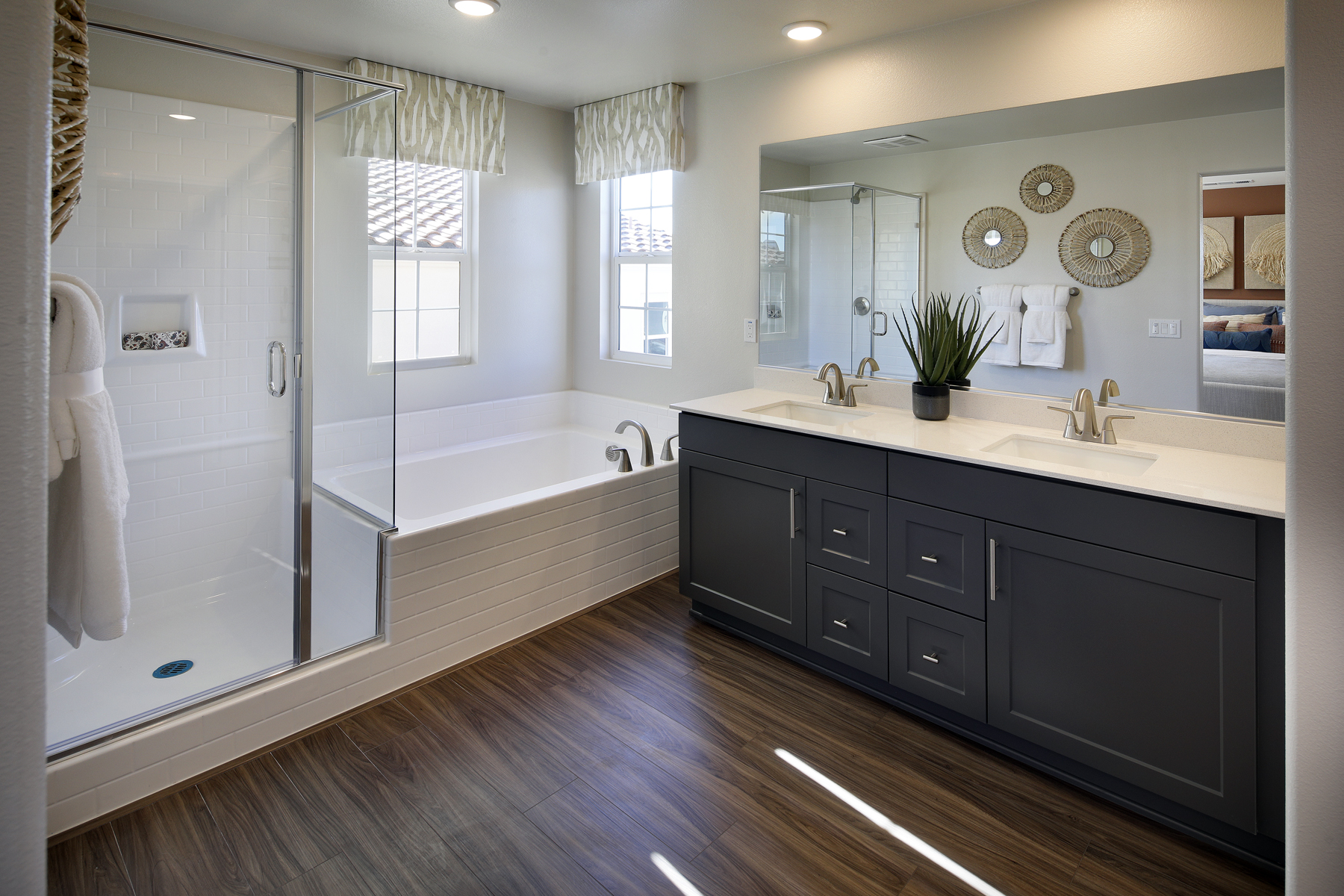A bathroom with a tub sink and a shower.