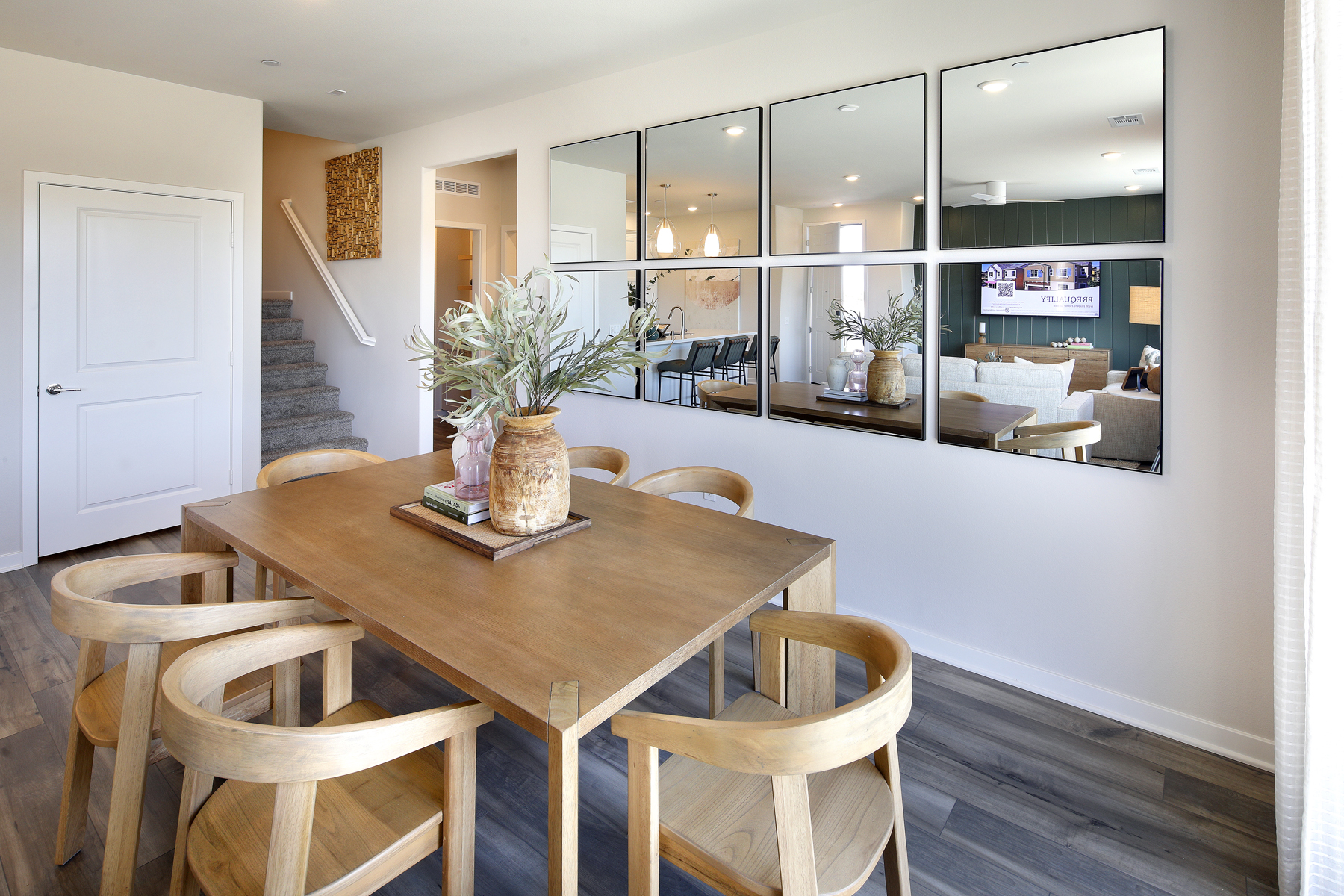 A dining room table with chairs.