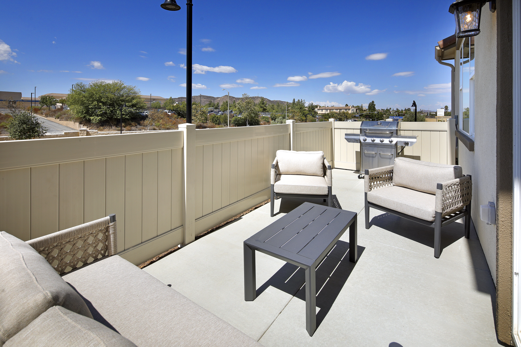 A deck with chairs and a table.