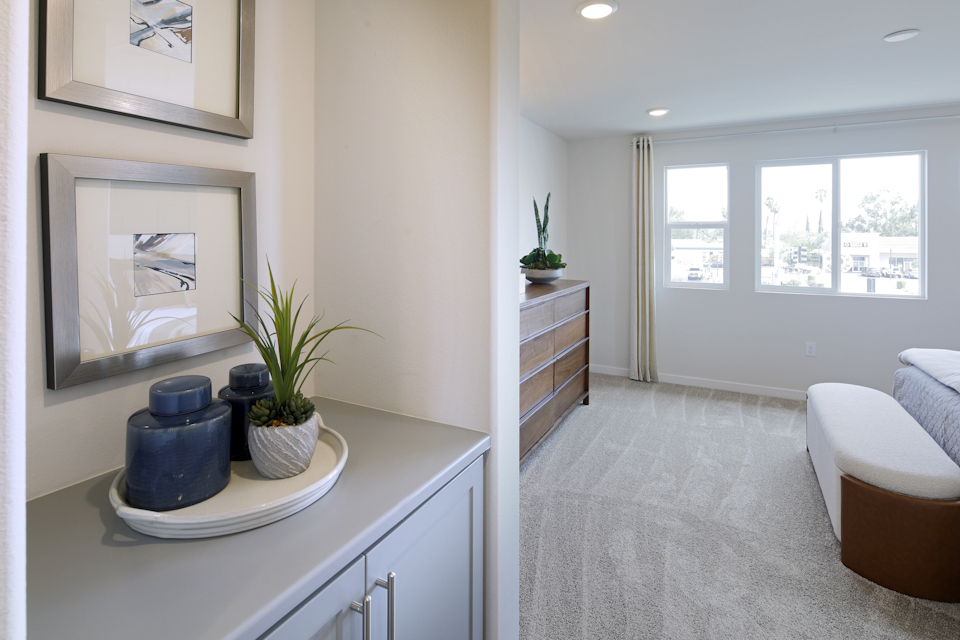 A room with a white counter and a white couch and a white table.