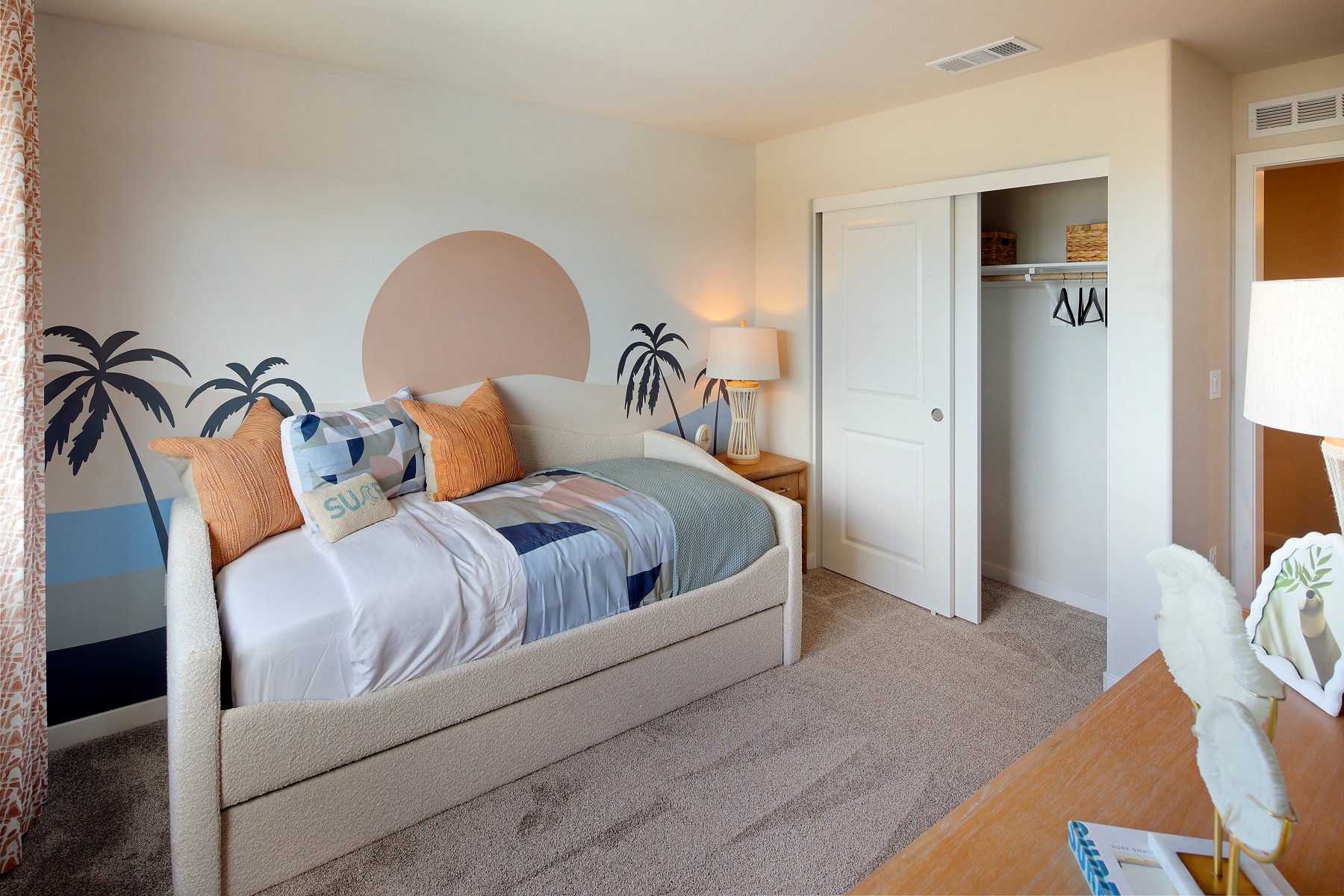 A bedroom with a bed and a lamp.