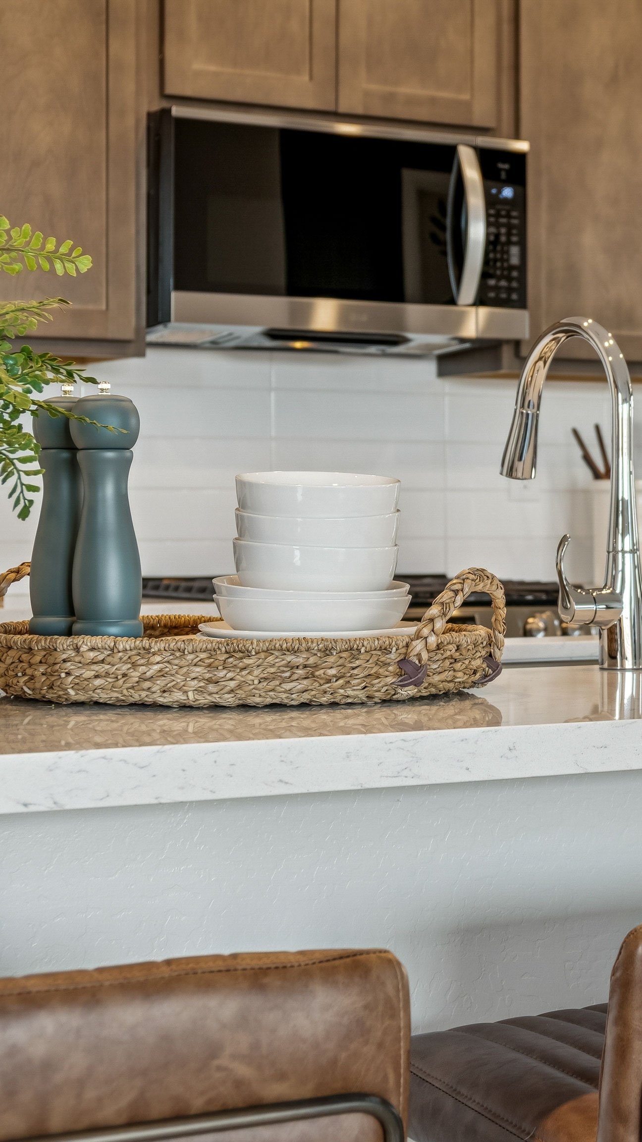 Photo of Kitchen with Burlap upgraded cabinets, brushed nickel hardware and kitchen island with barstools in Casa Grande AZ- New Construction Home For Sale by Century Communities with community amenities