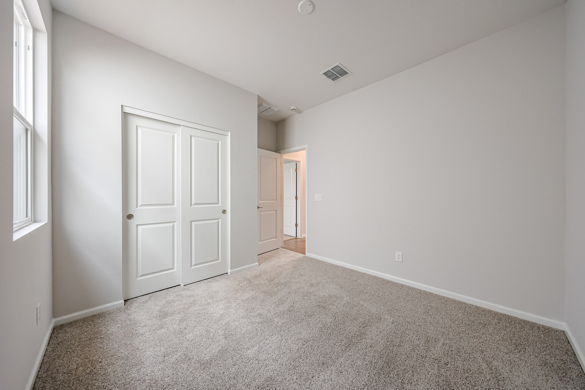 A hallway with white doors.