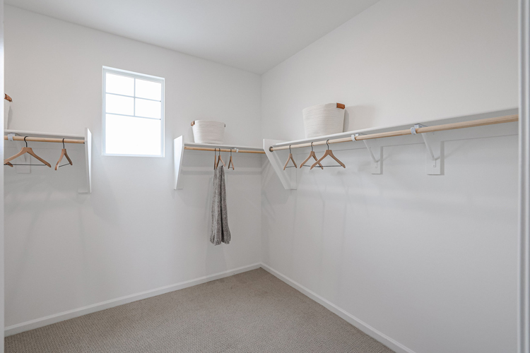 A white room with a white wall and a white chair.
