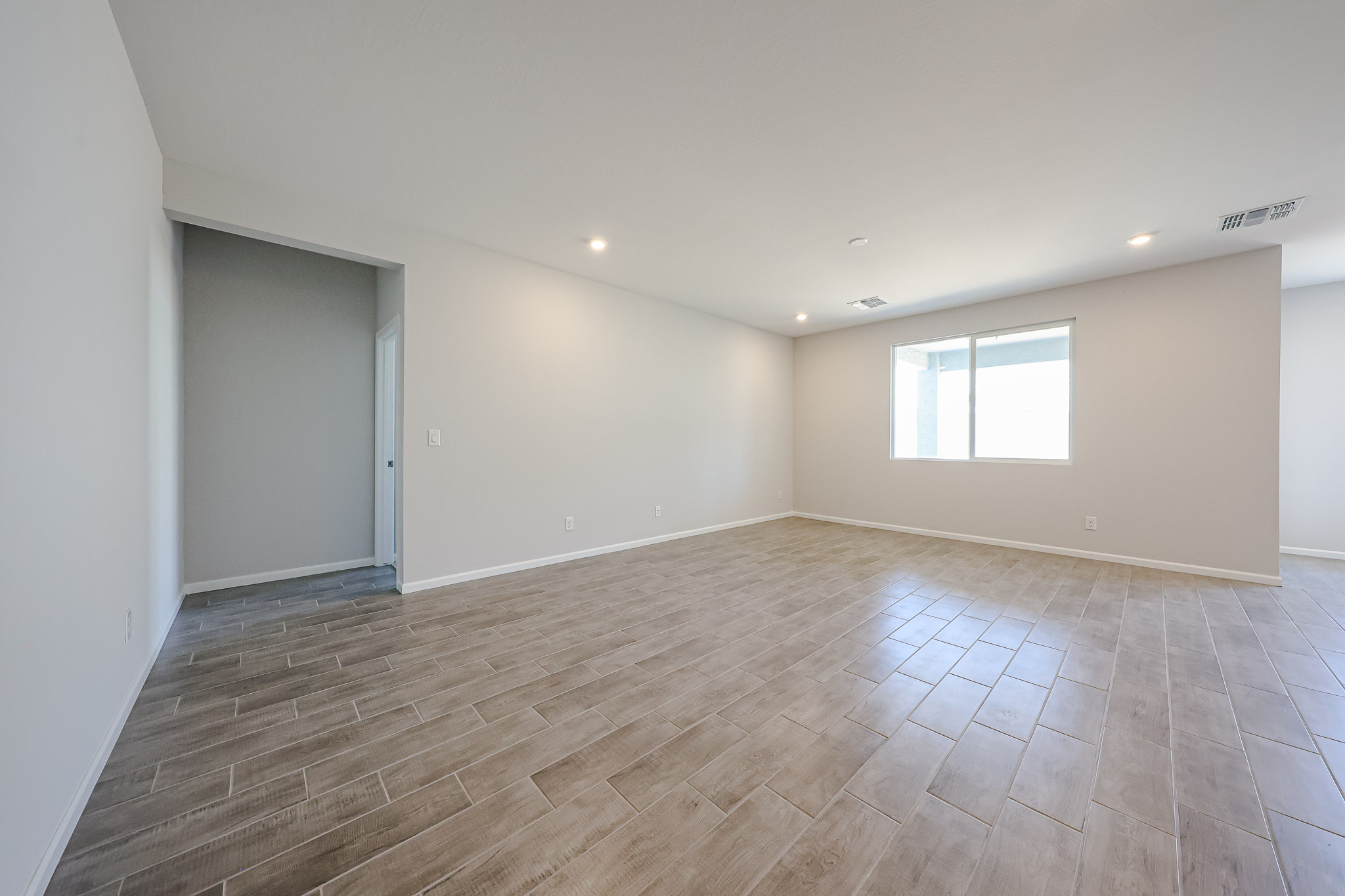 A room with a wood floor and a wood floor.