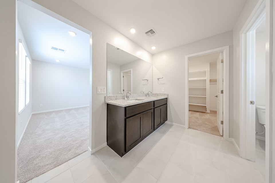 A bathroom with a marble countertop.