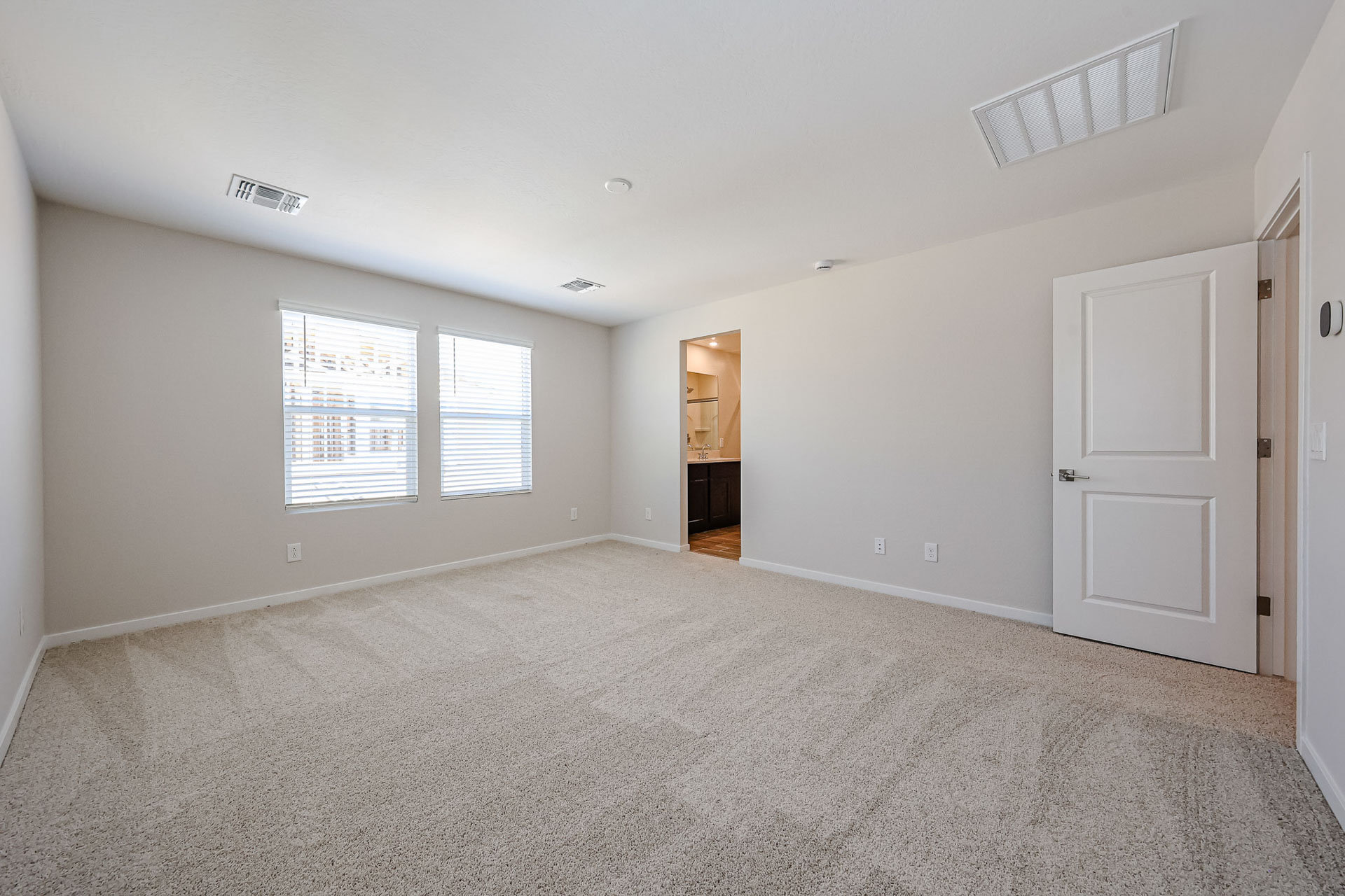 A room with white walls and a carpeted floor.