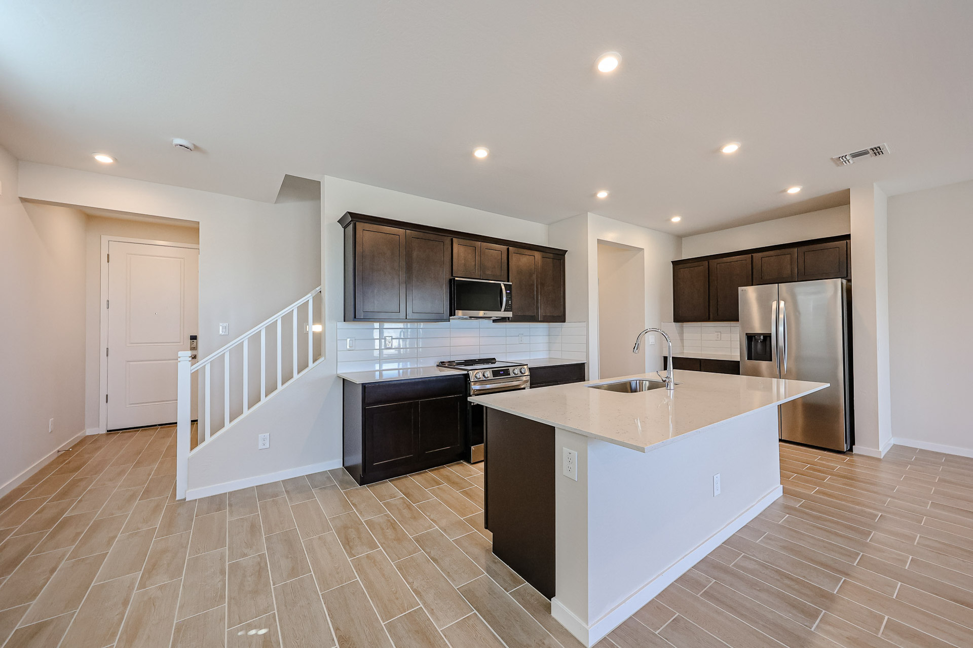 A kitchen with wooden cabinets.