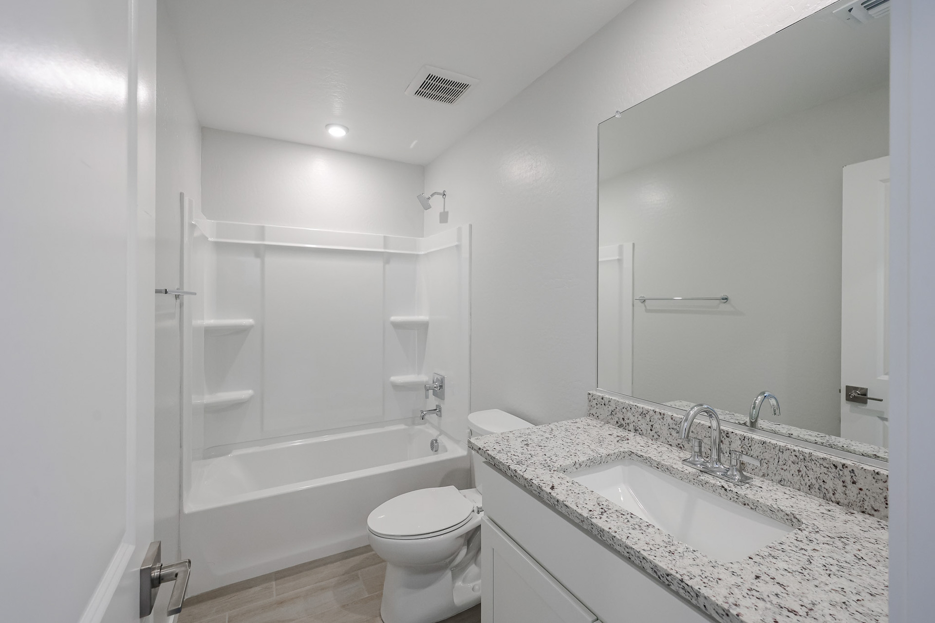 A bathroom with a tub sink and toilet.