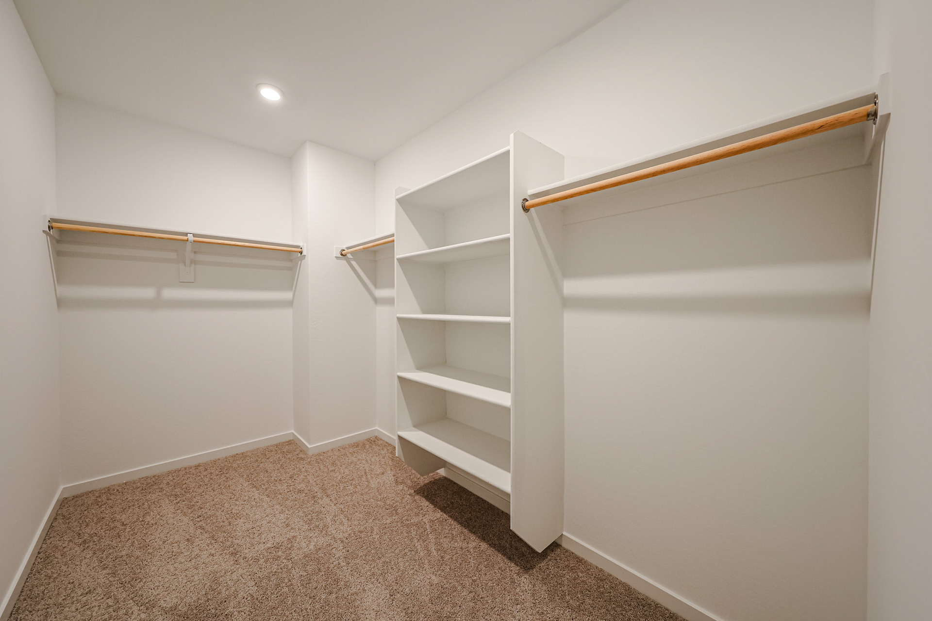 A white room with a white shelf.