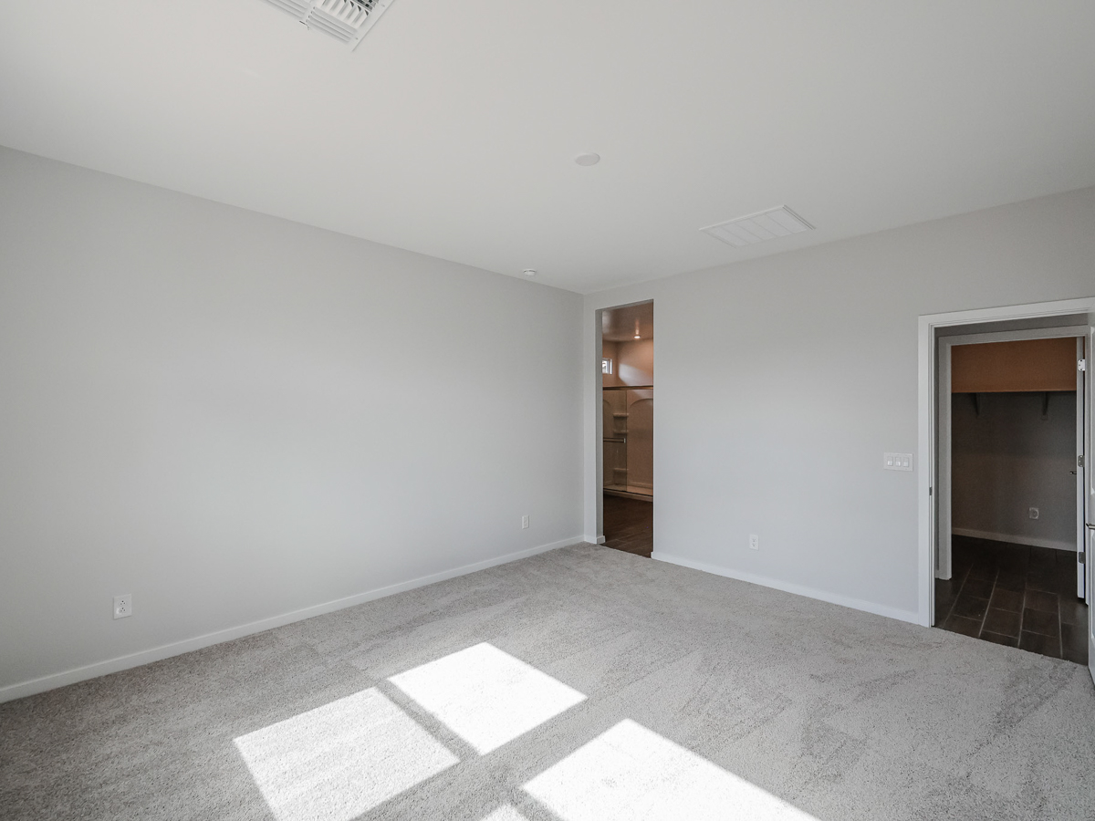 A room with a tile floor and a door.