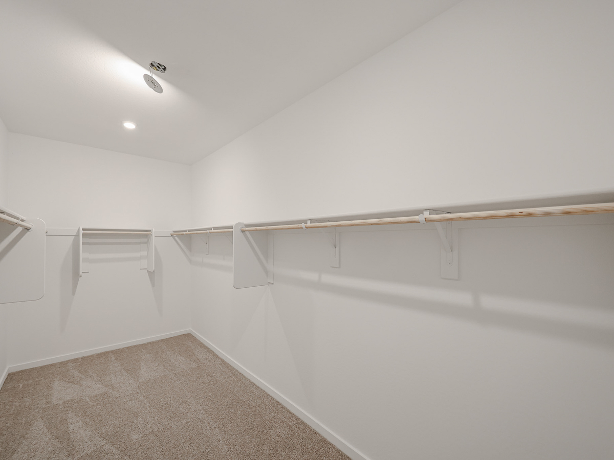 A white wall with a metal bar.