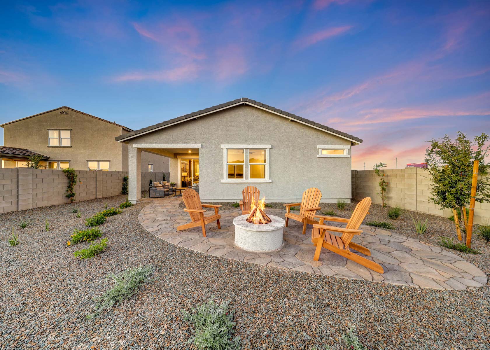 A backyard with a fountain and chairs.