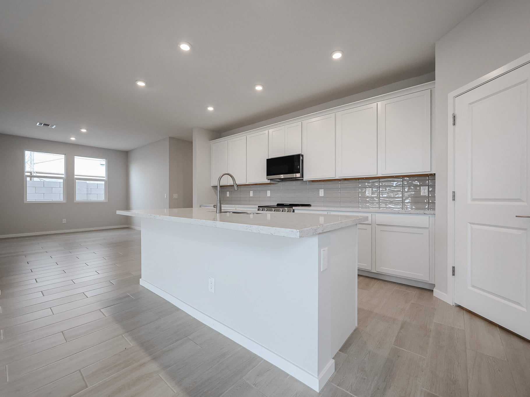 A kitchen with white cabinets.