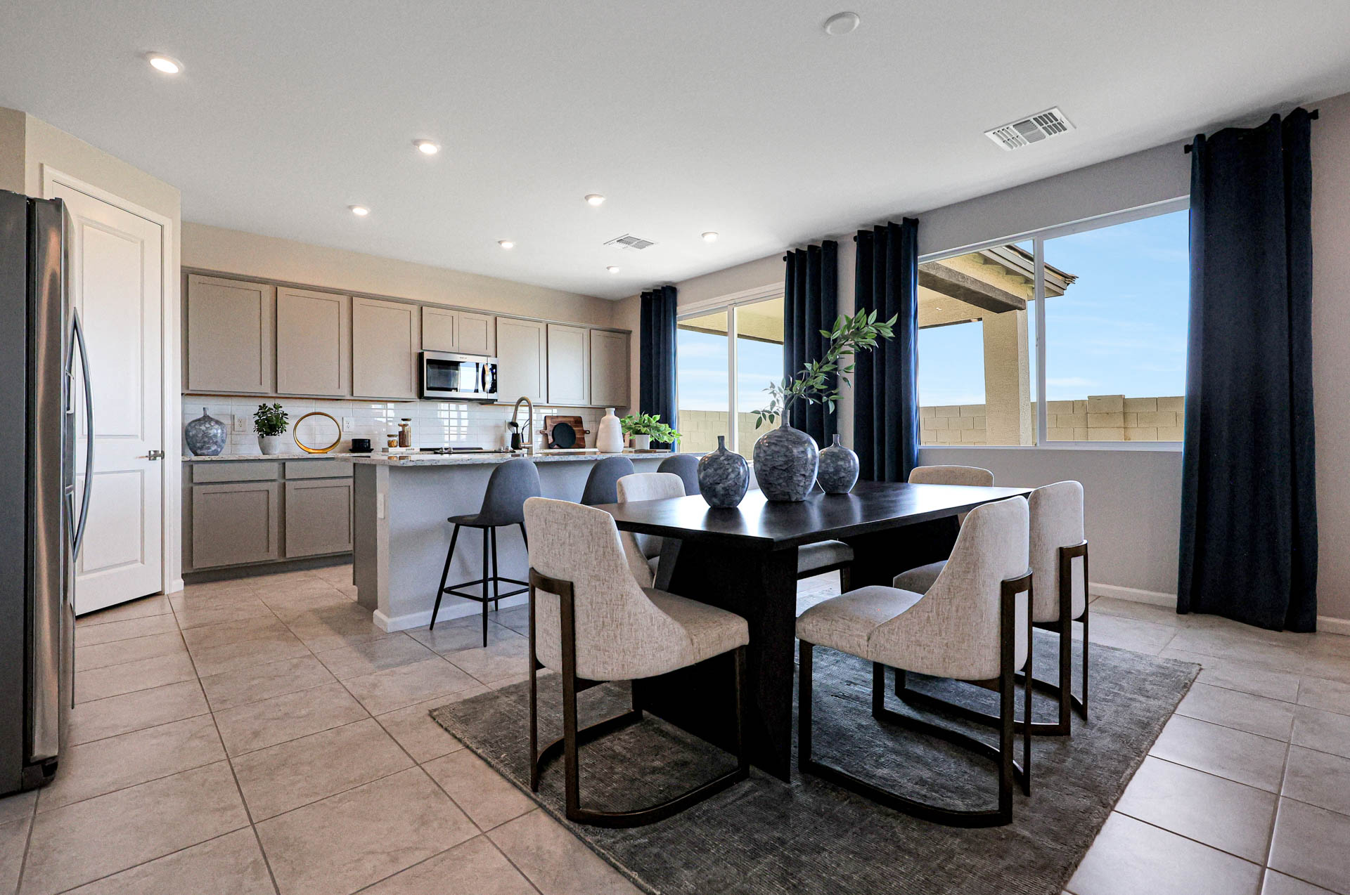 A kitchen with a dining table and chairs.