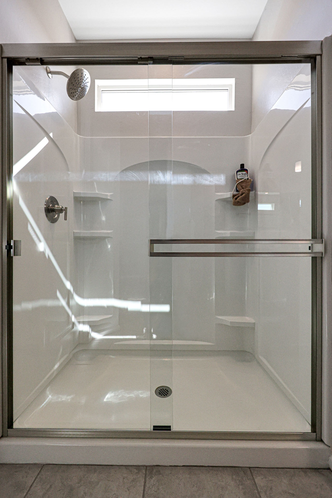 A shower with a glass door.