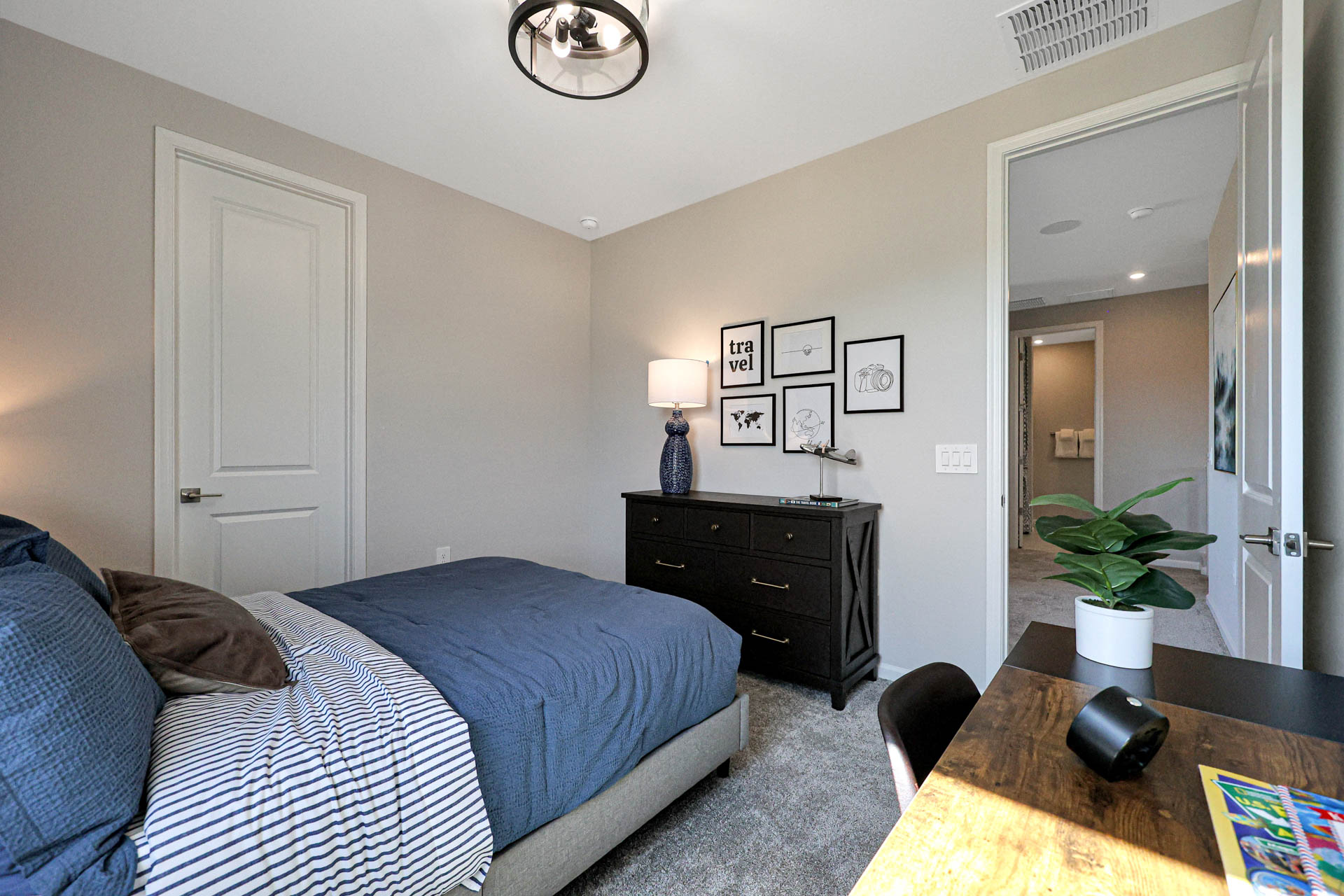 A bedroom with a bed and a table.