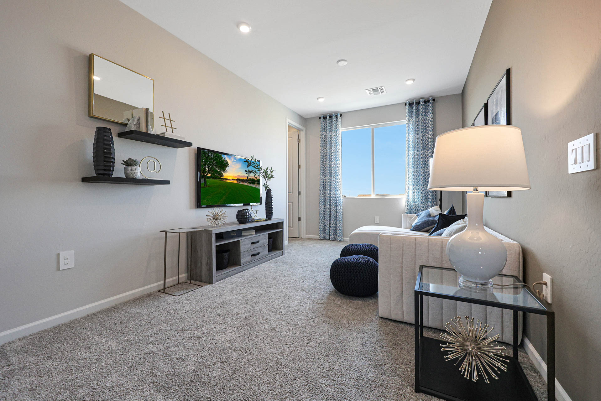 A living room with a tv and a lamp.