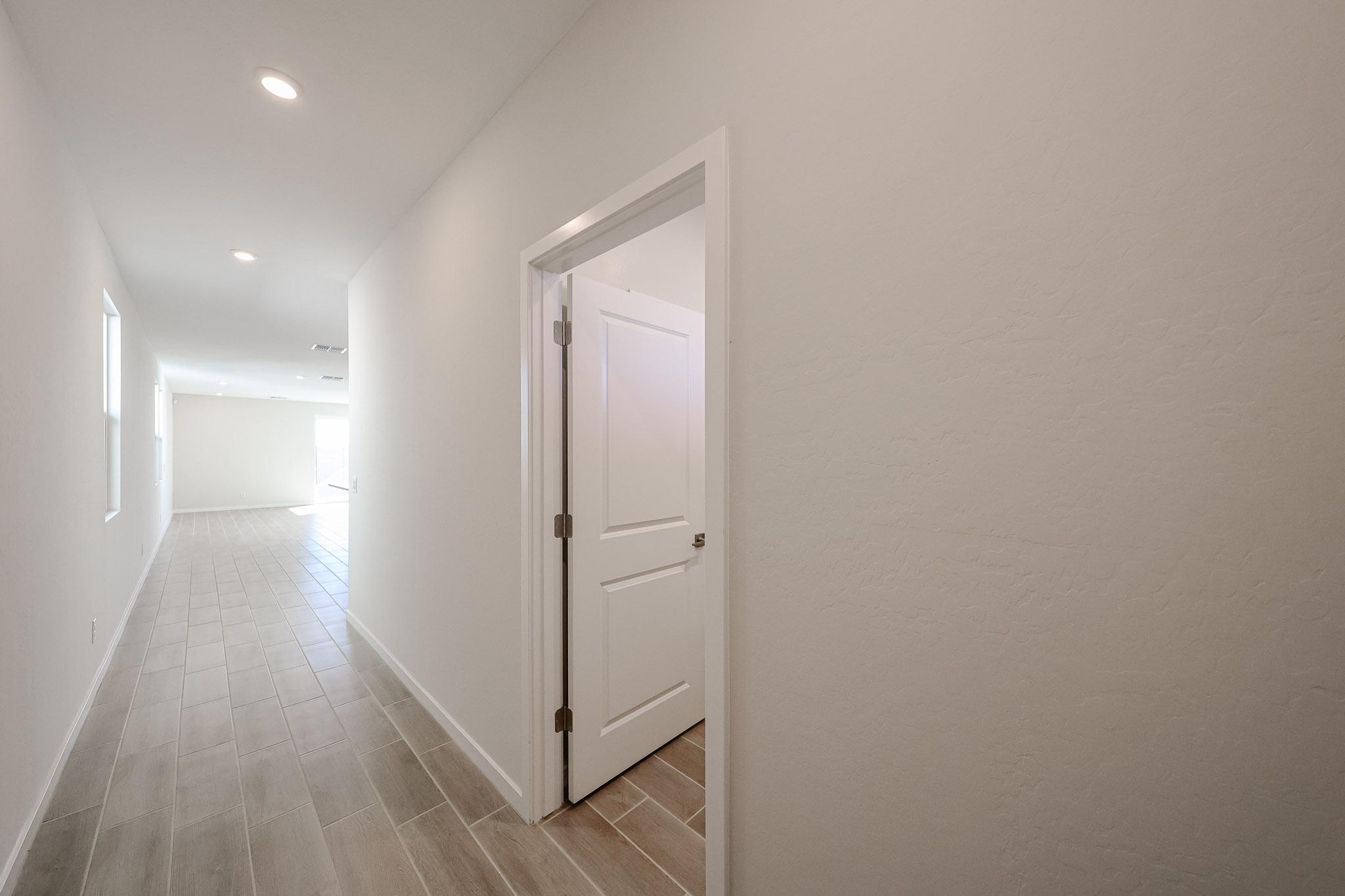 A hallway with white doors.