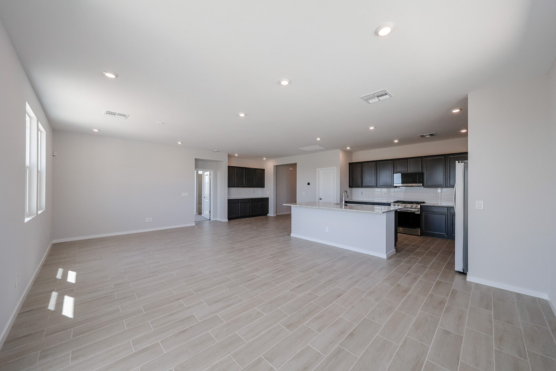 A large kitchen with black cabinets.