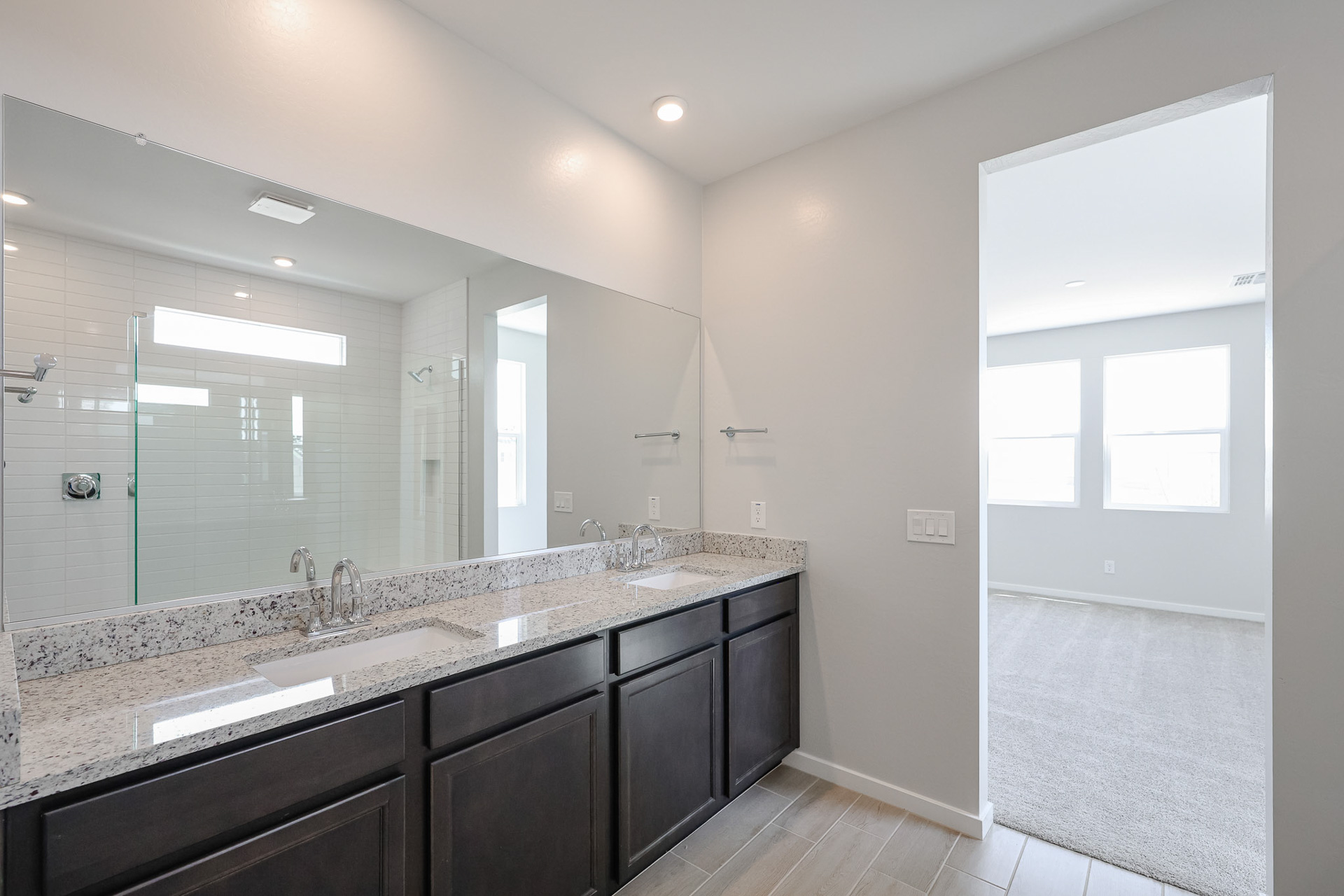 A bathroom with a large mirror.