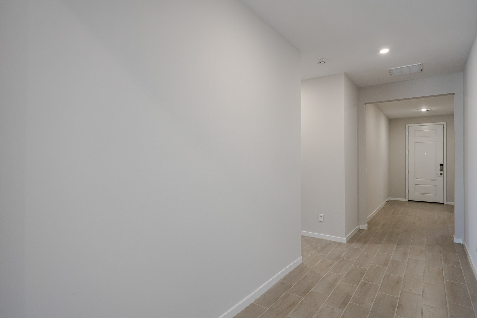 A hallway with white walls.