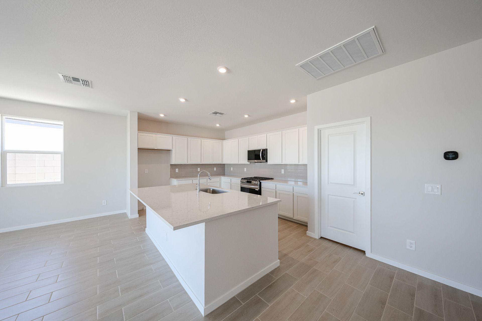 A kitchen with white cabinets.