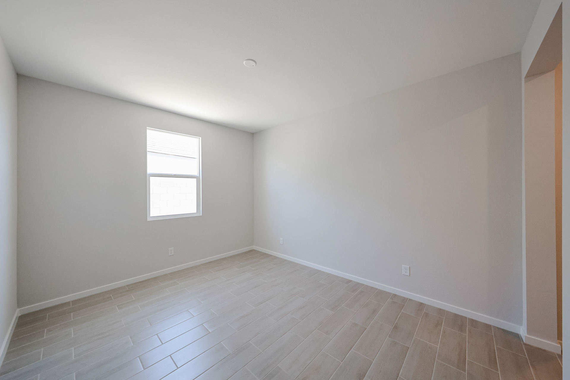 A room with a tile floor and windows.