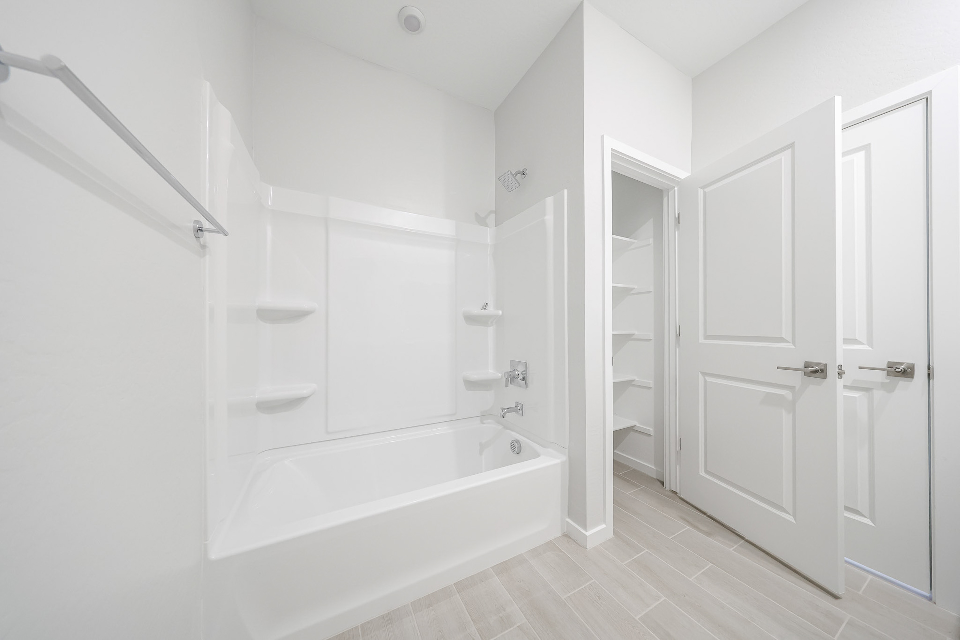A bathroom with white cabinets.