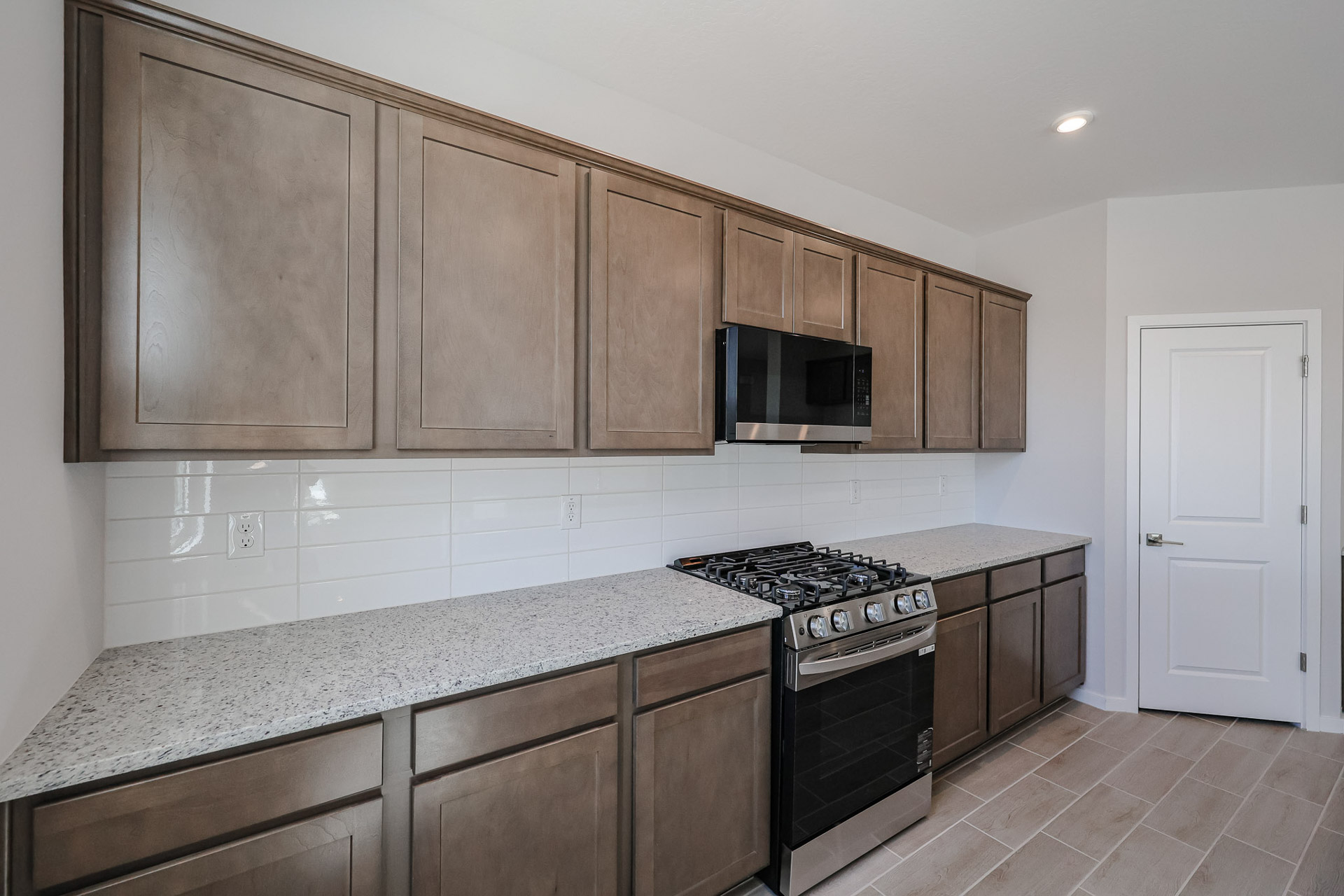 A kitchen with wooden cabinets.