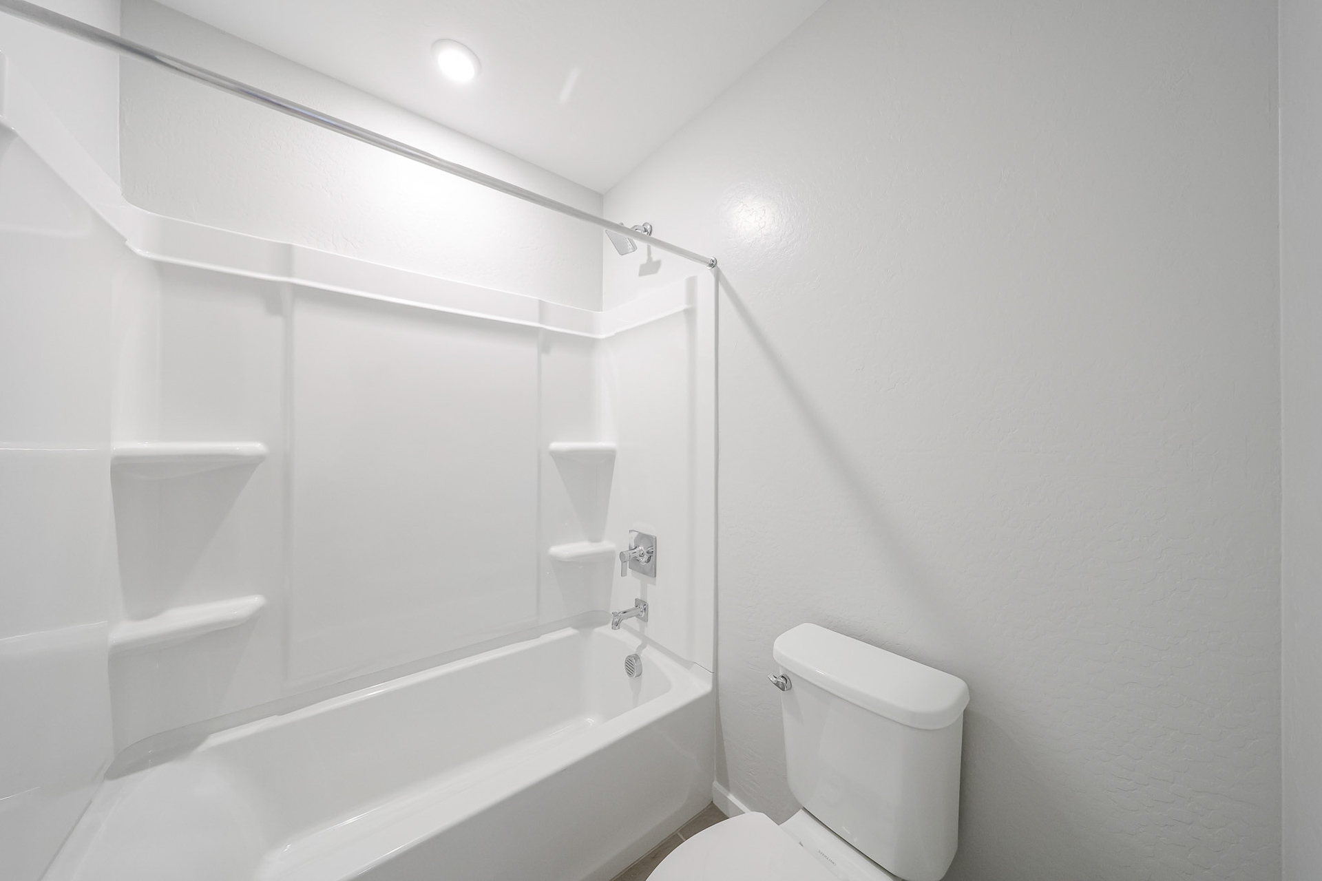A bathroom with a tub toilet and sink.